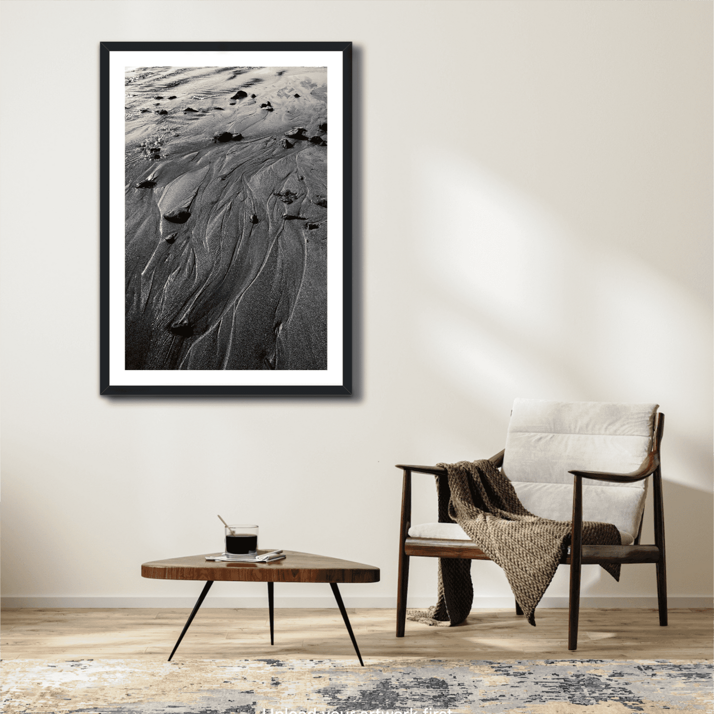 Vertical black and white sand artwork 'Traces #3' displayed in a cozy reading nook, adding serene coastal texture to modern interiors.