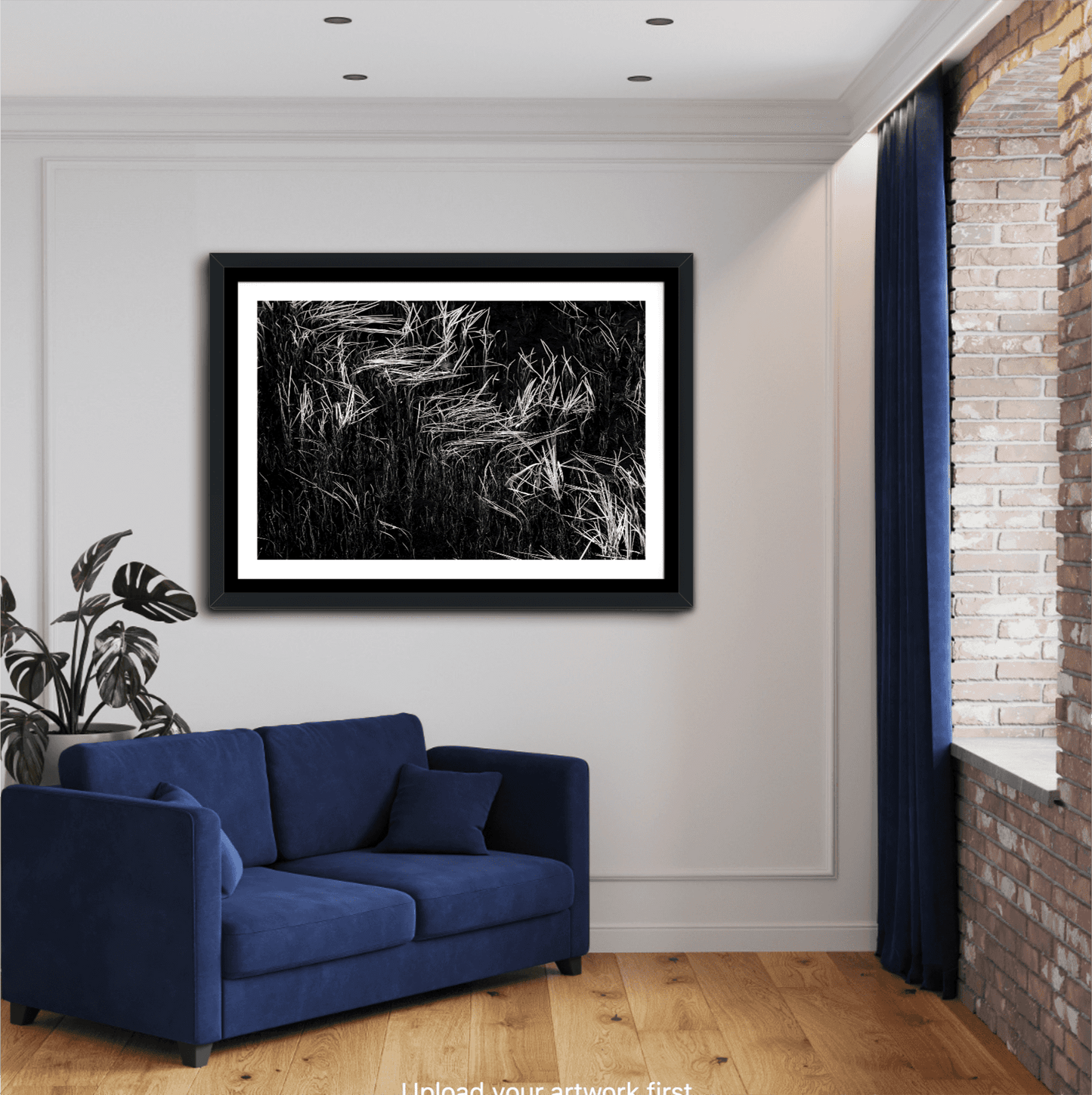 Framed Reeds in Water – Grand Teton Fine Art Black & White Landscape by Michael Hart above a blue couch. Monochrome artwork for stylish interiors.