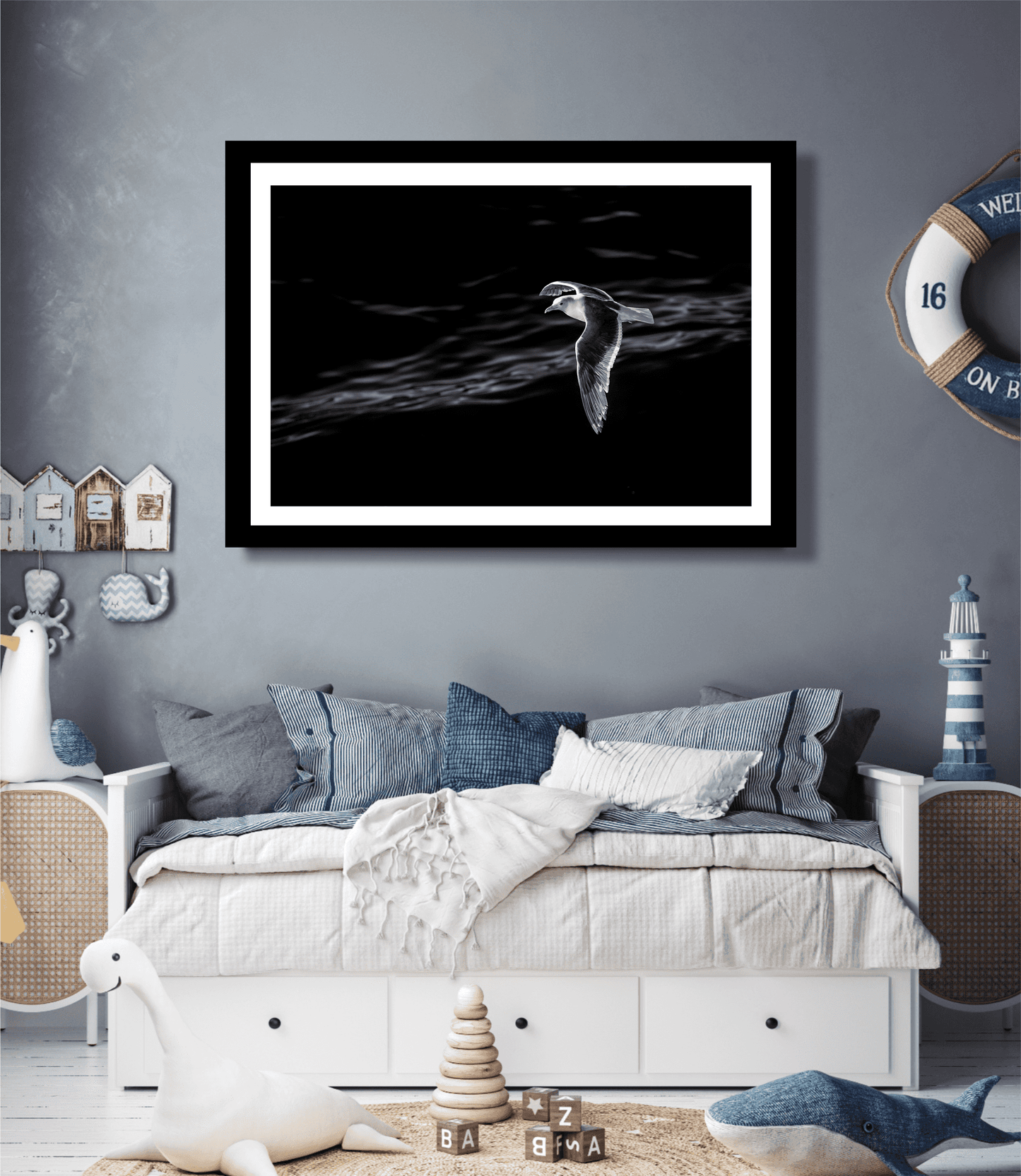 Graceful Flight – A Seagull Over Puget Sound in Black & White print decorates a nautical-themed kids' bedroom, blending nature and coastal charm.