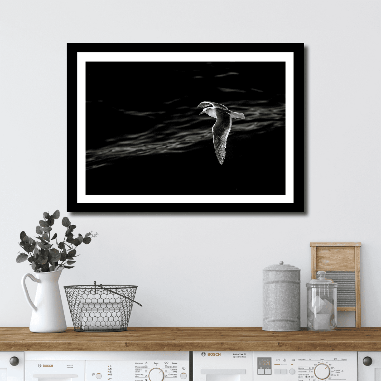 Graceful Flight – A Seagull Over Puget Sound in Black & White framed artwork adds a peaceful touch to a laundry room with modern farmhouse decor.