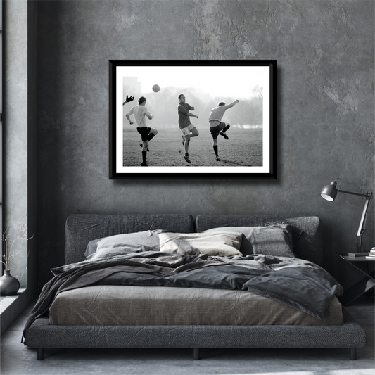 Black and white street photography print of three men playing football in Hyde Park, London