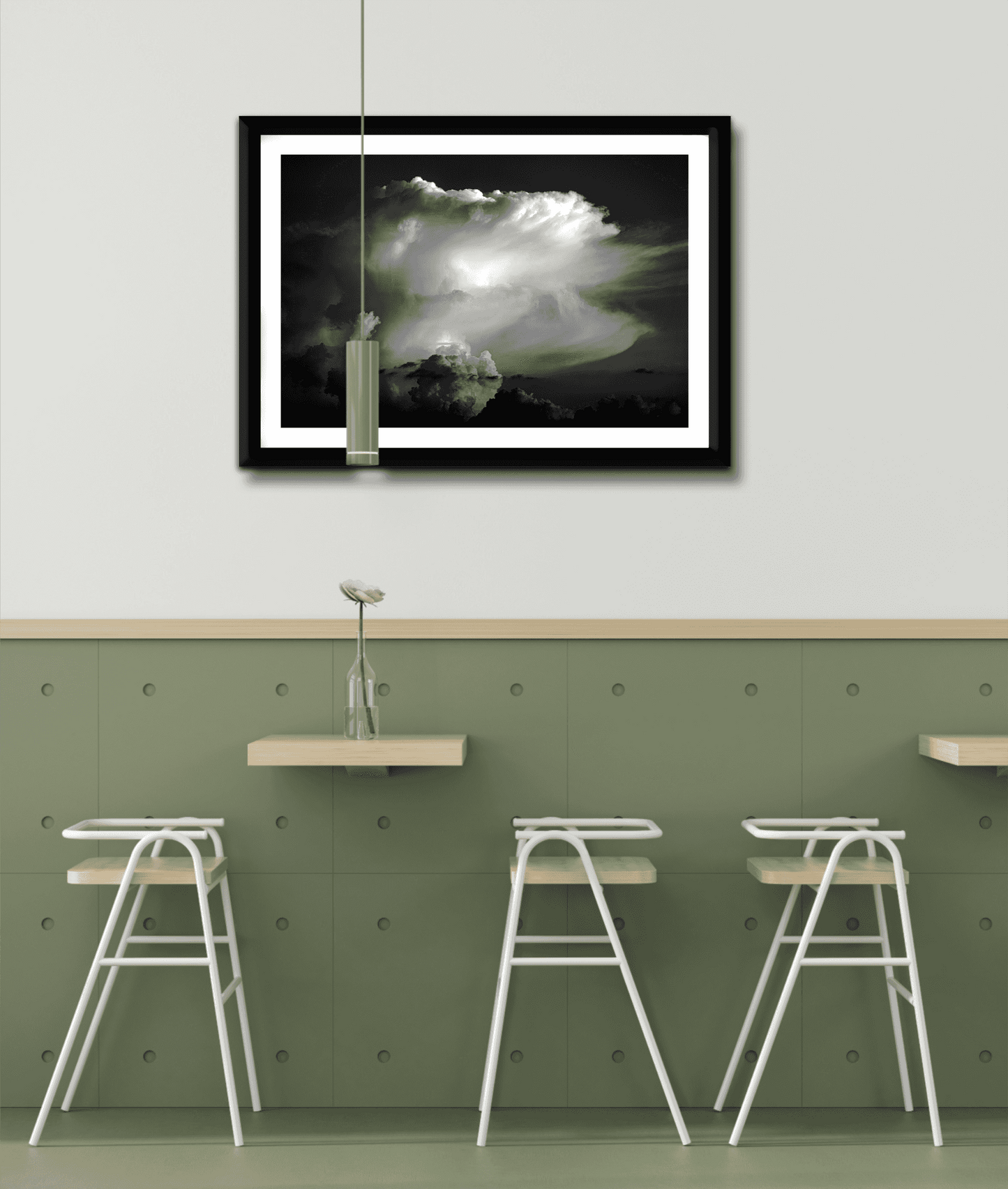 Thunderhead, Magnolia TX – Dynamic Texas Clouds in Black and White framed artwork above a green accent wall with bar seating in a contemporary cafe.