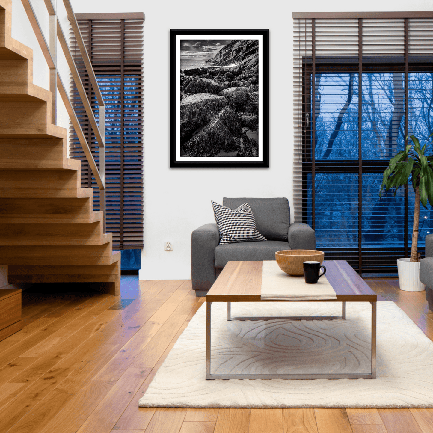 After Doré – Moody Black and White Coastal Photography displayed in a cozy living room, adding dramatic seascape art to a modern home setting.