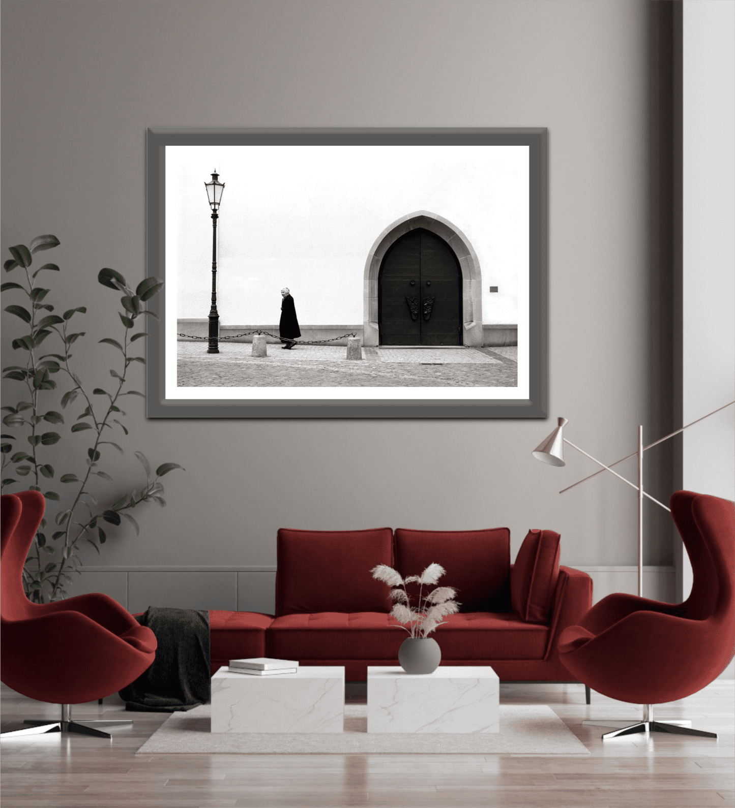 Zurich Series #2 – The Woman and the Church, Black and White Fine Art Print by Michael Hart displayed above a red sofa in a modern living room, enhancing minimalist decor.