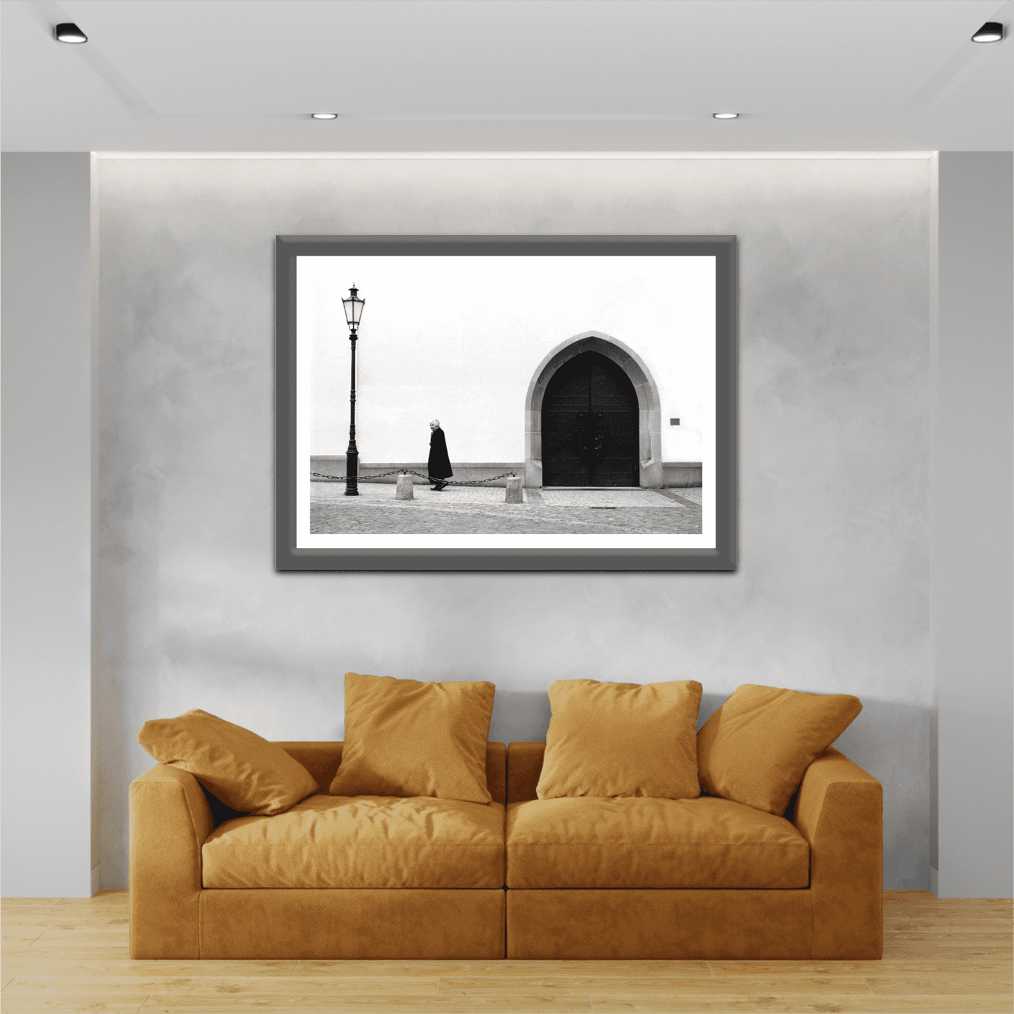 Zurich Series #2 – The Woman and the Church, Black and White Fine Art Print by Michael Hart framed above a tan couch in a contemporary interior with soft lighting.