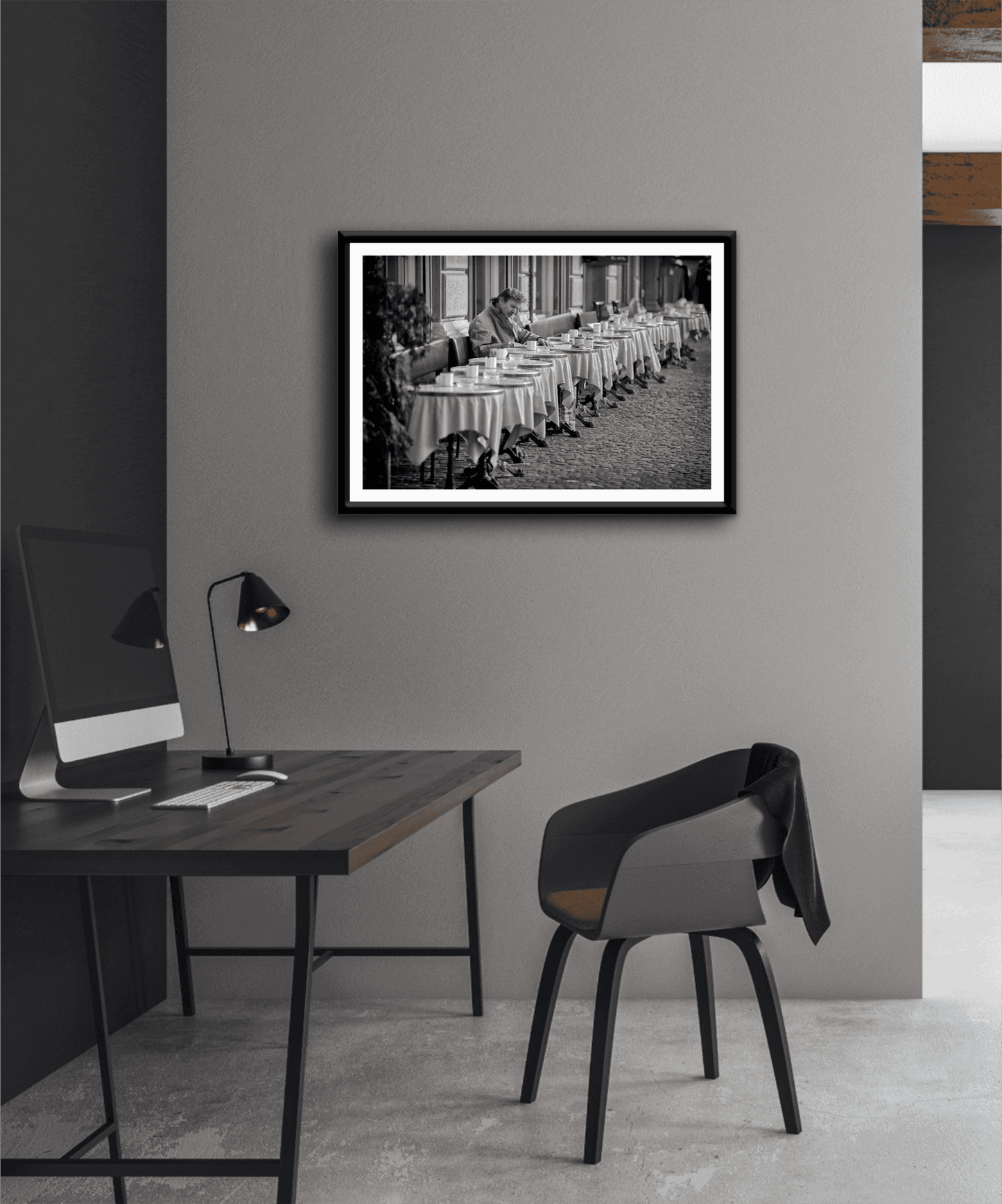 Zurich Series #3 – The Man at the Café, Zurich in Black and White – Fine Art Print by Michael Hart styled in a minimalist home office. A contemplative black and white print for modern workspace decor.