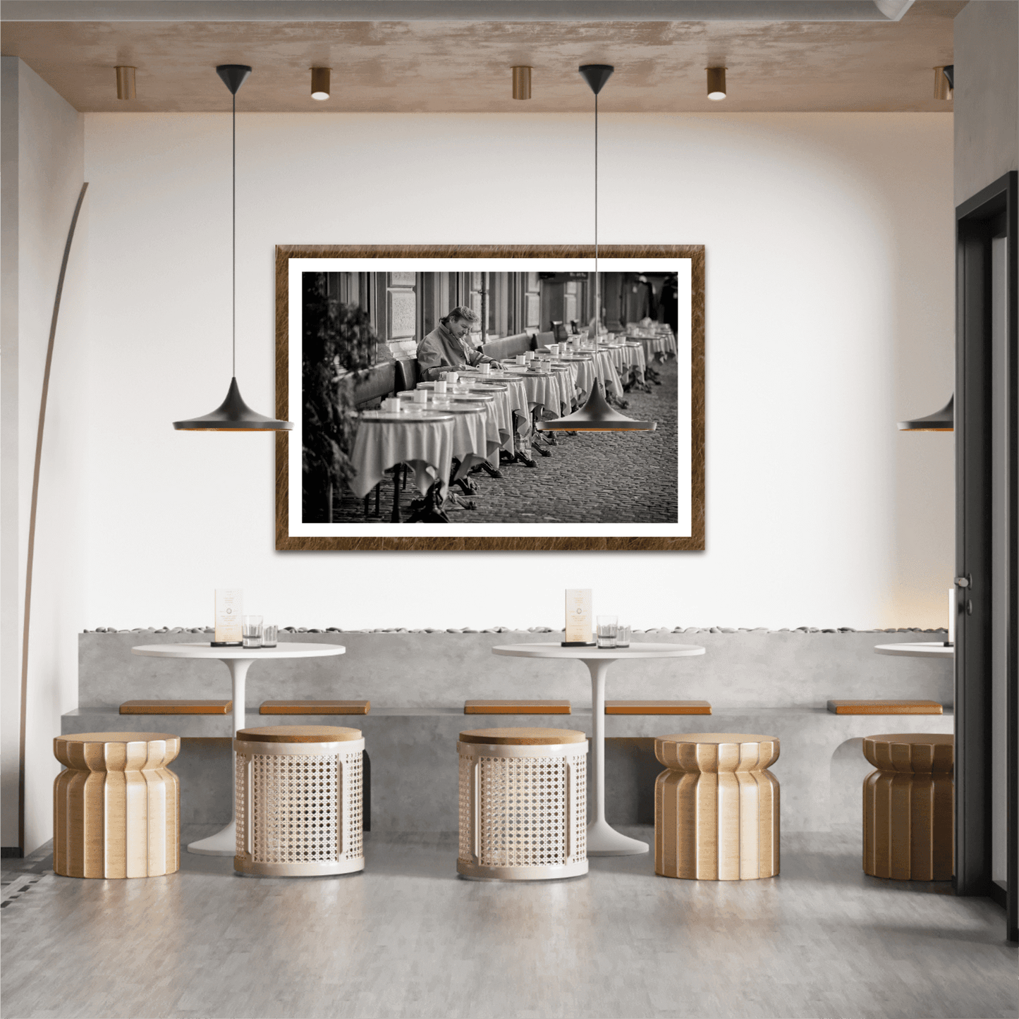 Zurich Series #3 – The Man at the Café, Zurich in Black and White – Fine Art Print by Michael Hart featured in a stylish café interior. A timeless European street scene in black and white perfect for hospitality decor.