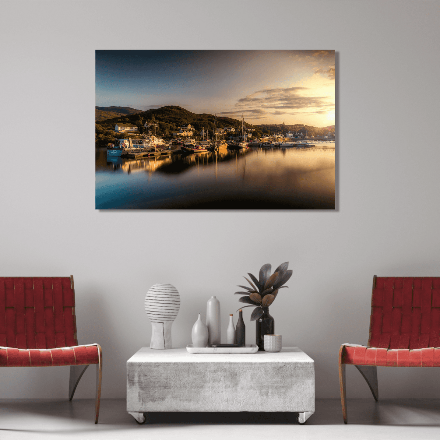 Golden Light over Kyleakin Harbor – Isle of Skye landscape image by Michael Hart displayed in a modern living room with red chairs and minimalist decor. This fine art Scotland print captures a tranquil harbor scene at golden hour, ideal for interior design and collectors.