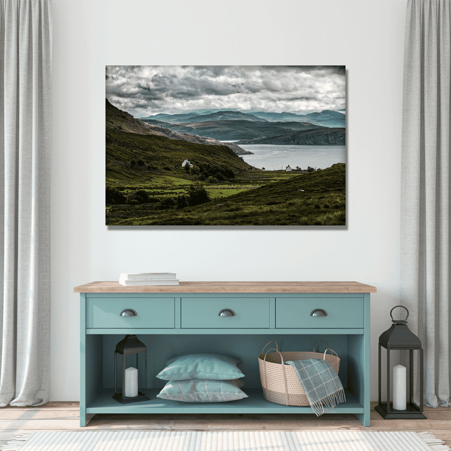 Scotland’s Wild West Coast in Light and Shadow artwork mounted above a teal console table, complementing rustic decor with Highland scenery.