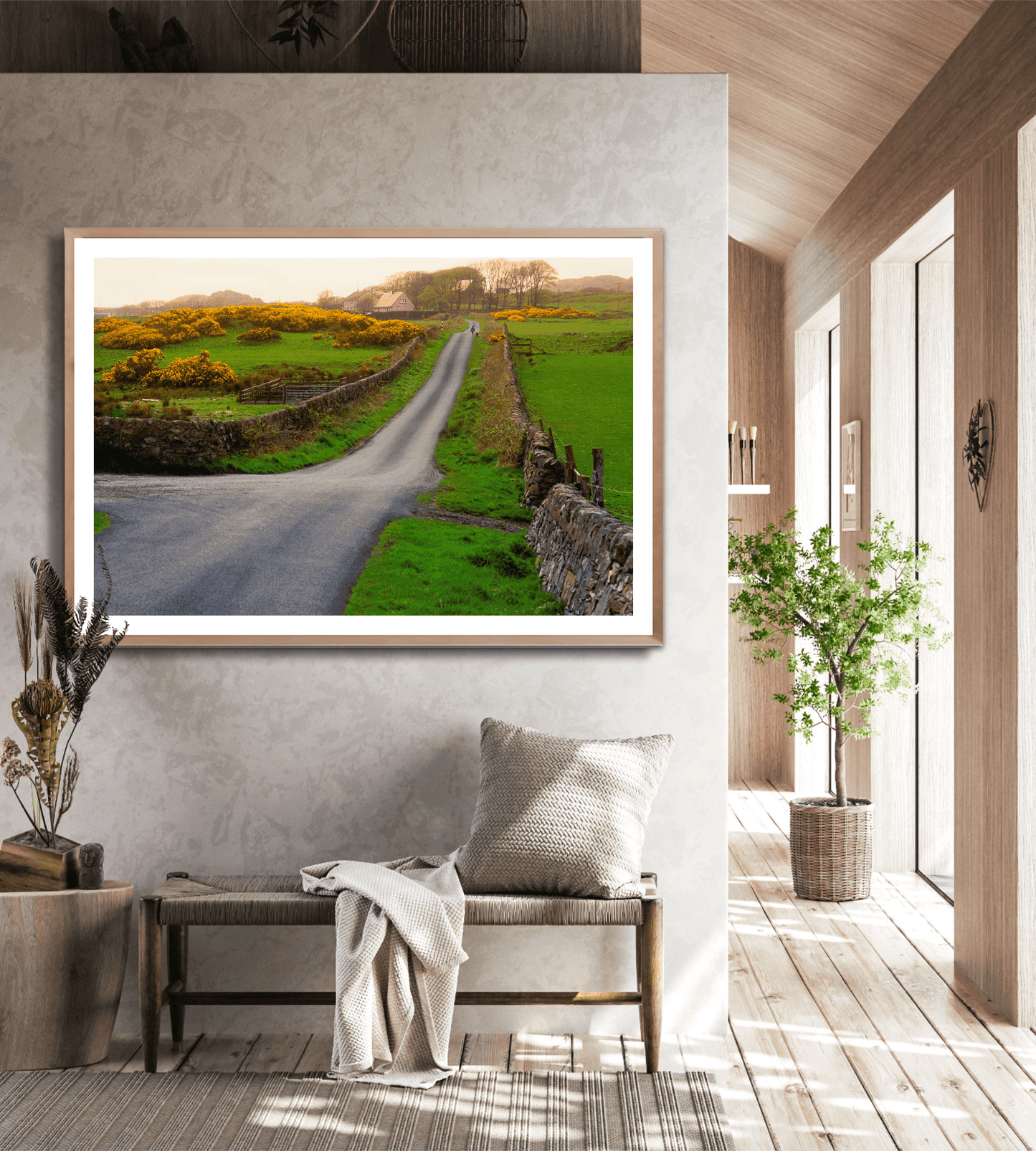 Limited edition Islay Whisky Scenic Print framed in a rustic hallway, highlighting a peaceful Scottish road with a lass and dog amid lush greenery.