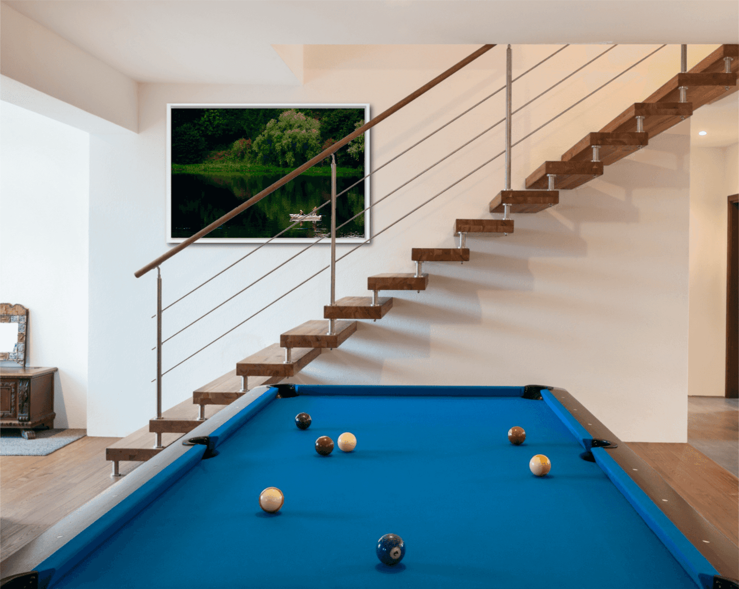 Fishermen on Linlithgow Loch – A Scene of Light, Gesture, and Color displayed above a modern staircase in a stylish game room with a pool table. Fine art print enhances interior design with tranquil Scottish landscape.
