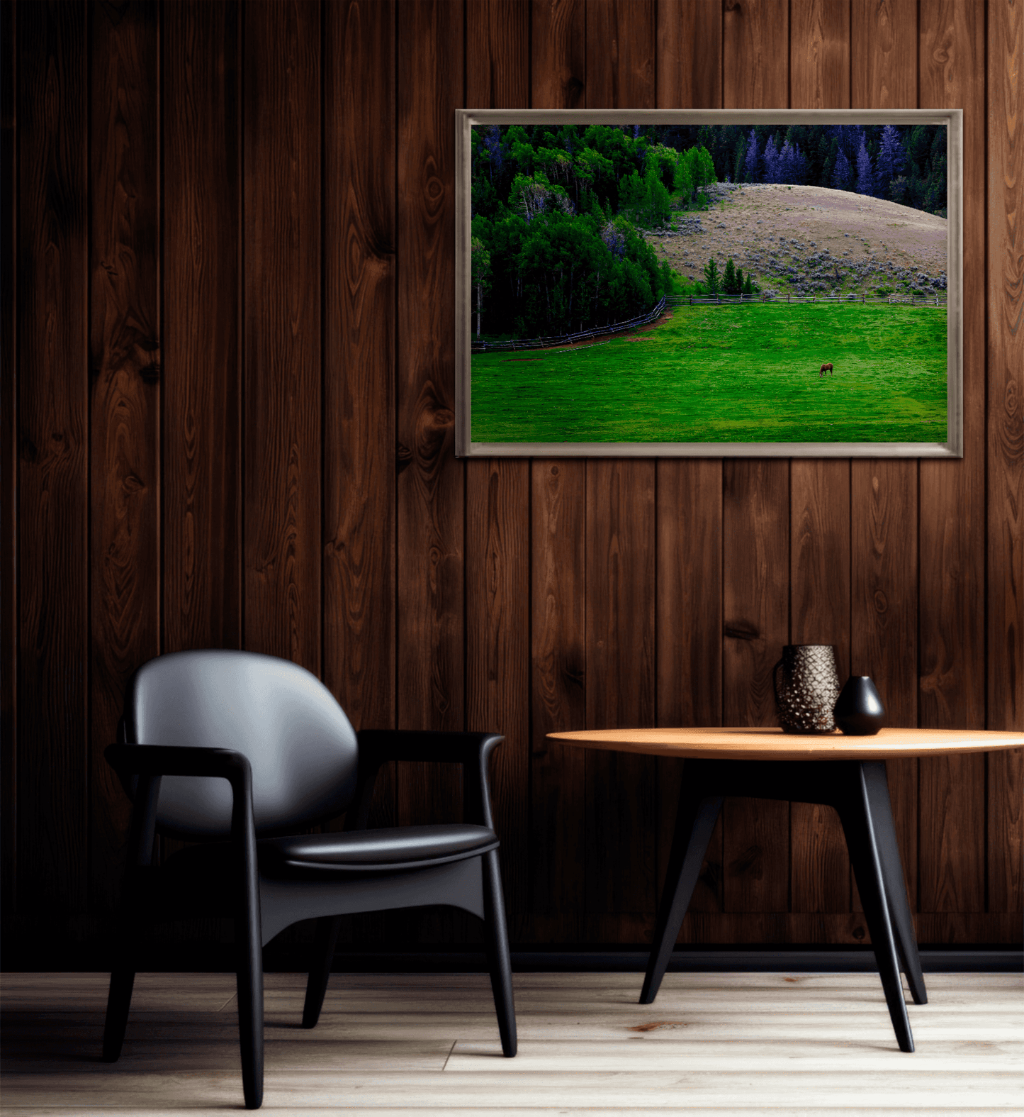 Fine art print of Lone Horse on Gros Ventre Ranch mounted on a dark wood-paneled wall above a modern black chair and round table. Adds serene Western charm to interiors.