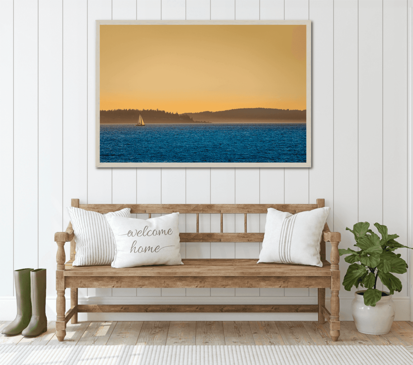 Golden Hour Sailboat framed print in a cozy entryway, capturing Puget Sound's sunset glow and peaceful sailboat silhouette.