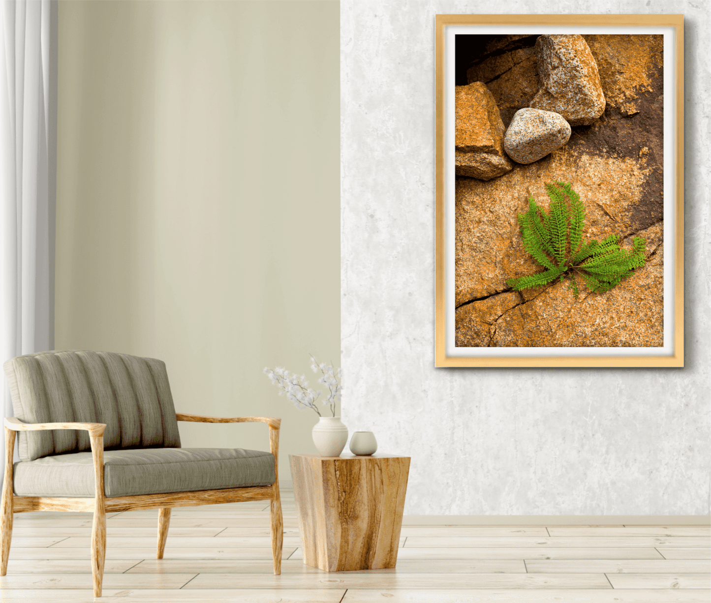 Framed Nature Breaking Through Stone fine art print displayed in minimalist living room, highlighting plant in rock crevice with warm earth tones.
