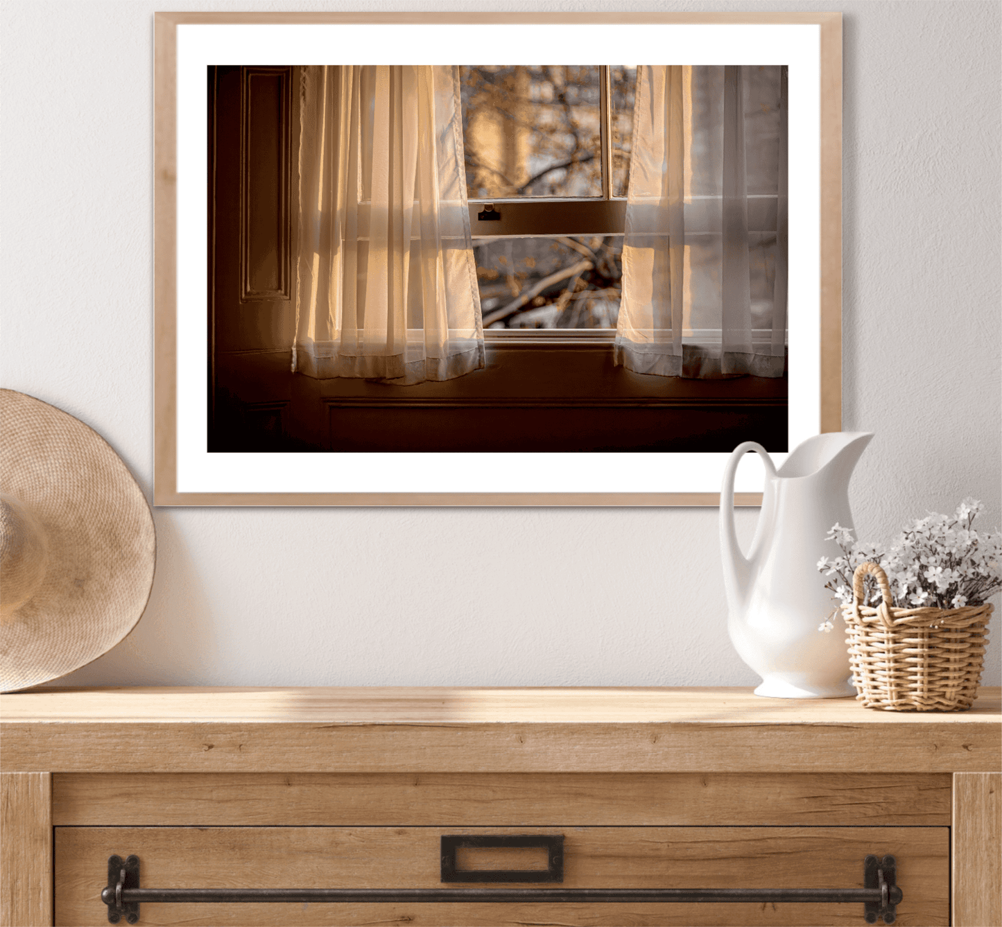 Framed fine art photo 'From A Window: Golden Light on Lace Curtains in a London Hotel Room' styled above a console table with rustic decor accents.