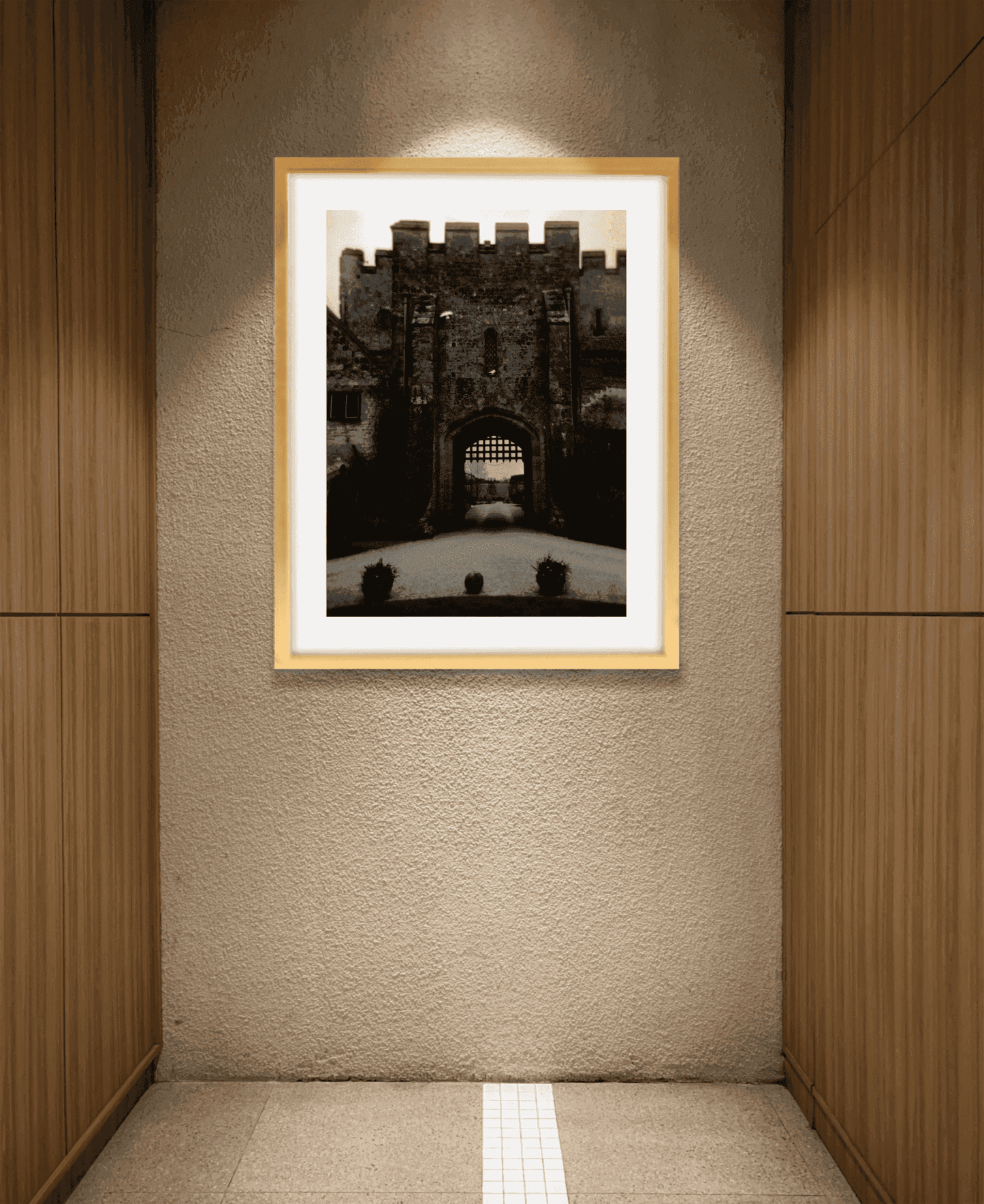 Amberley Gate – Limited Edition Fine Art Photograph displayed in a minimalist hallway. Features the portcullis gate of Amberley Castle in soft, atmospheric tones.