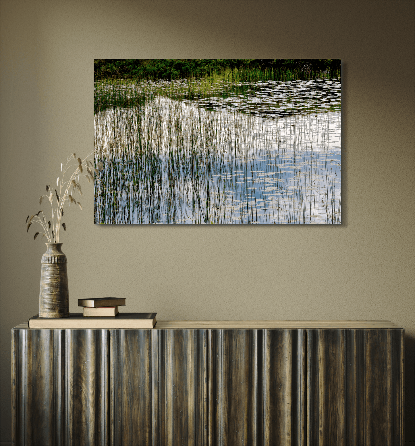 Reeds and Water artwork mounted above a dark wood console, blending natural textures with fine art photography in a cozy, earthy-toned room.
