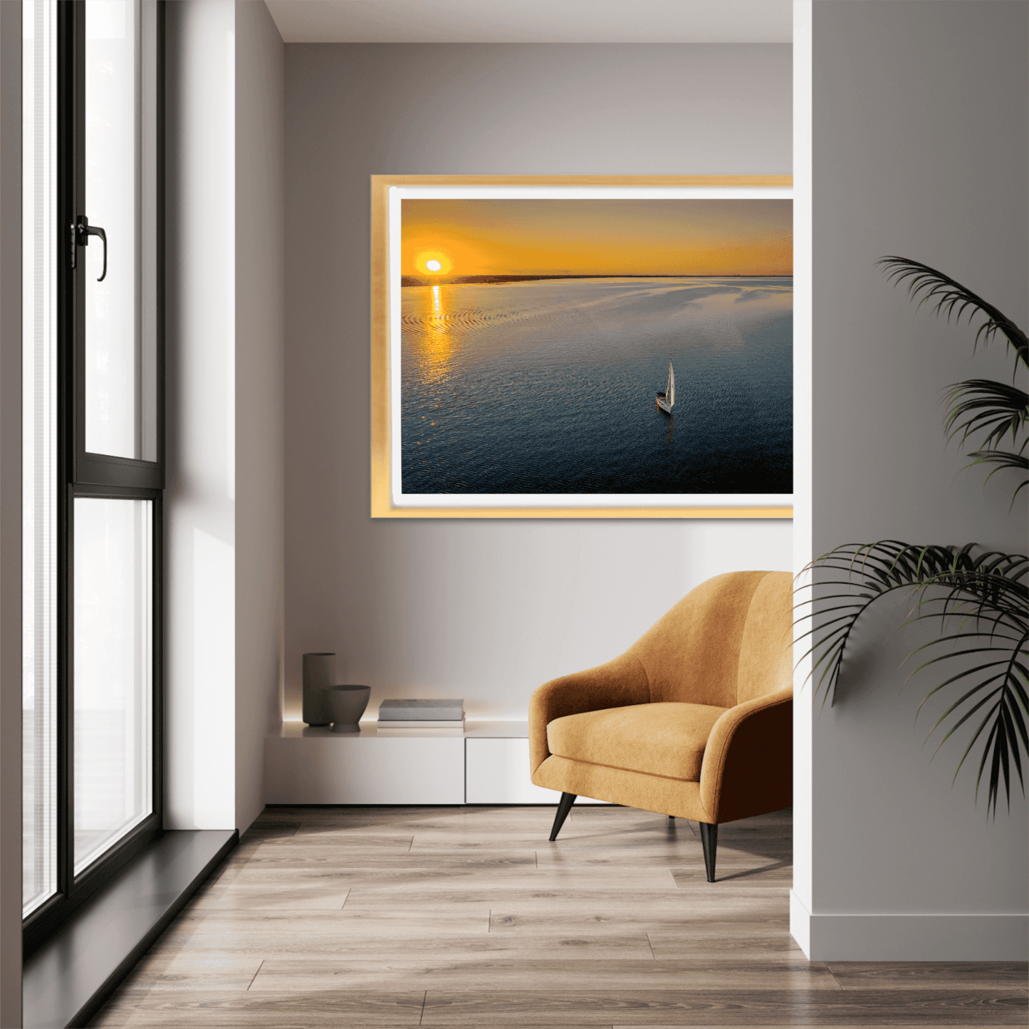 Sunset Sail – Fine Art Aerial Photograph Over Galveston Bay hung in a cozy reading nook. Golden sunset tones highlight the sailboat on tranquil waters.
