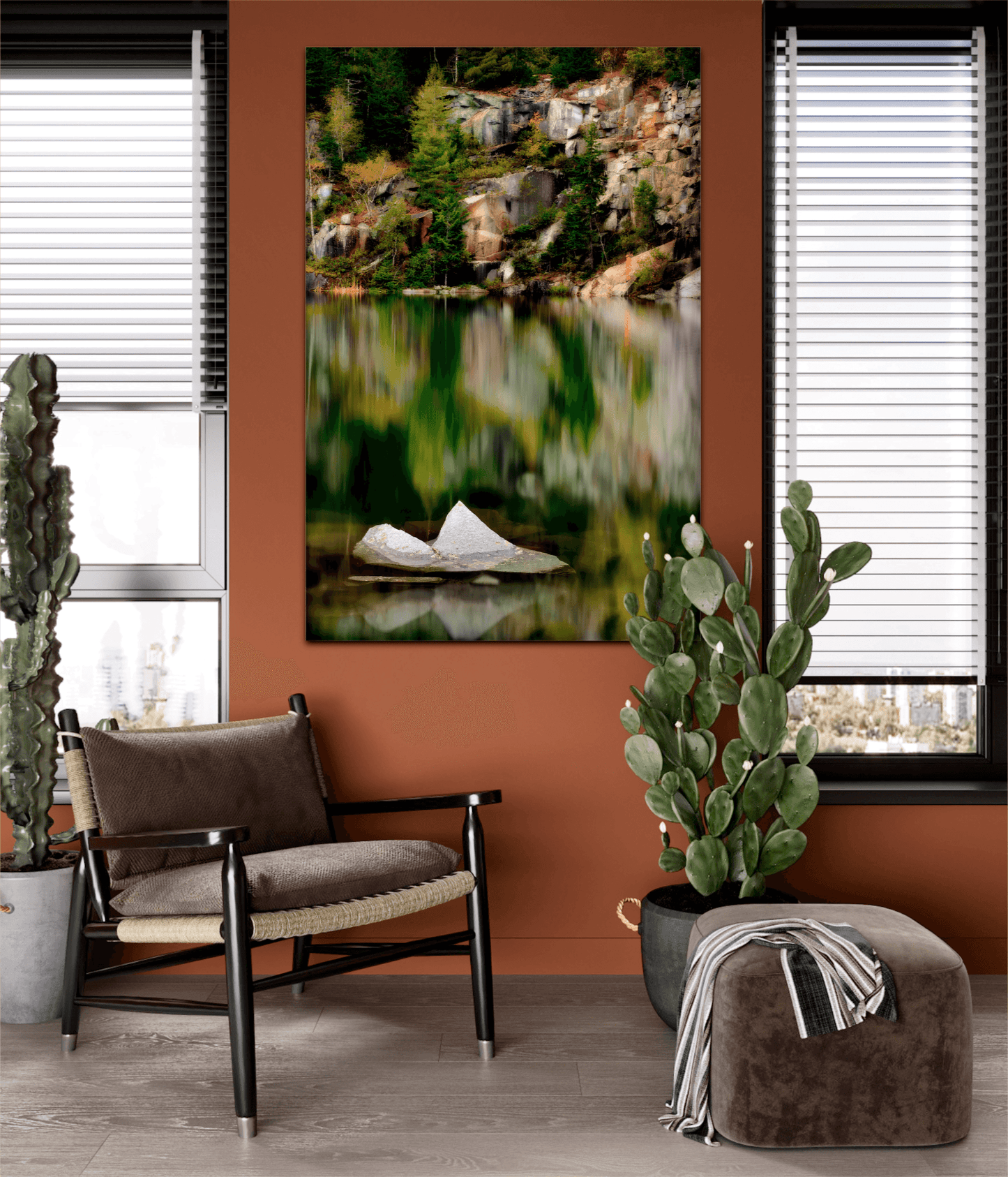 Vertical wall art of The Sentinel – A Lone Rock Emerges Above The Quarry Waterline, Maine adds a tranquil nature scene to a modern room with earthy tones and plants.
