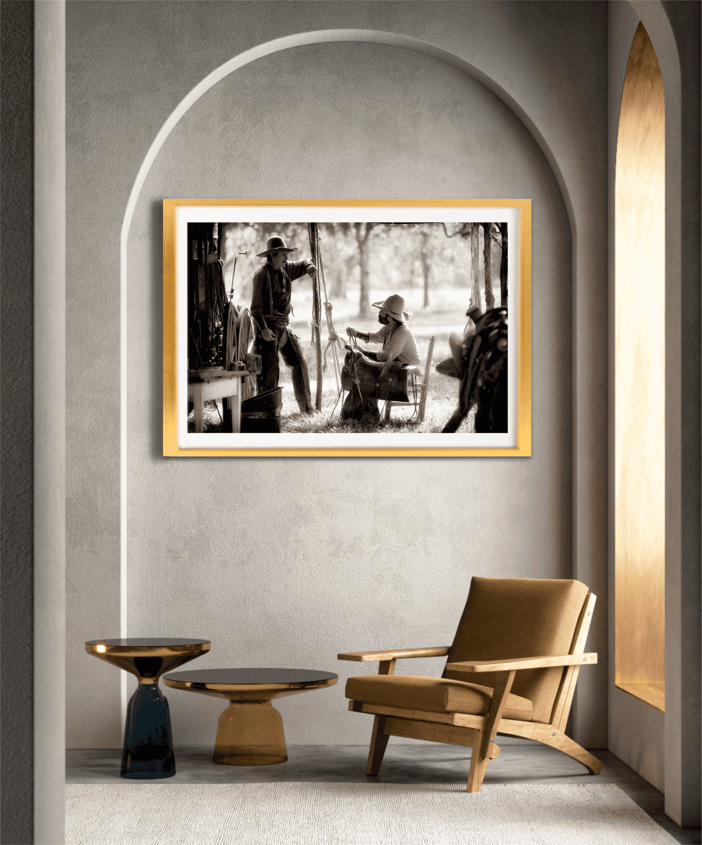 Sepia-toned cowboy heritage artwork 'Camp Talk: A Chuckwagon Cook-Off in Authentic Old West Style' framed in gold and showcased in a modern arched alcove with minimalist furniture.