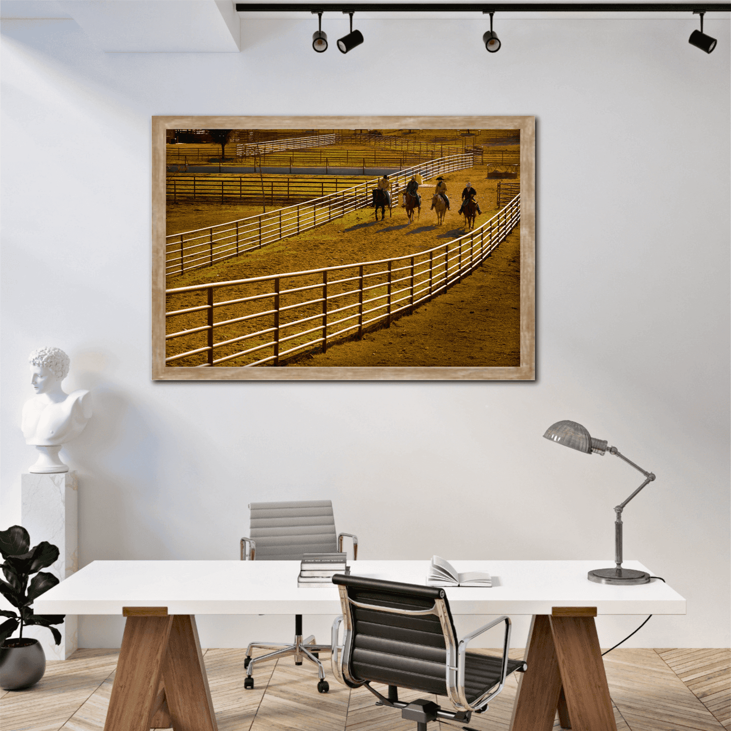 Cowboy Quartet: Morning Light and Motion at the Corral Texas ranch artwork displayed in a contemporary office with white walls and wood desk.