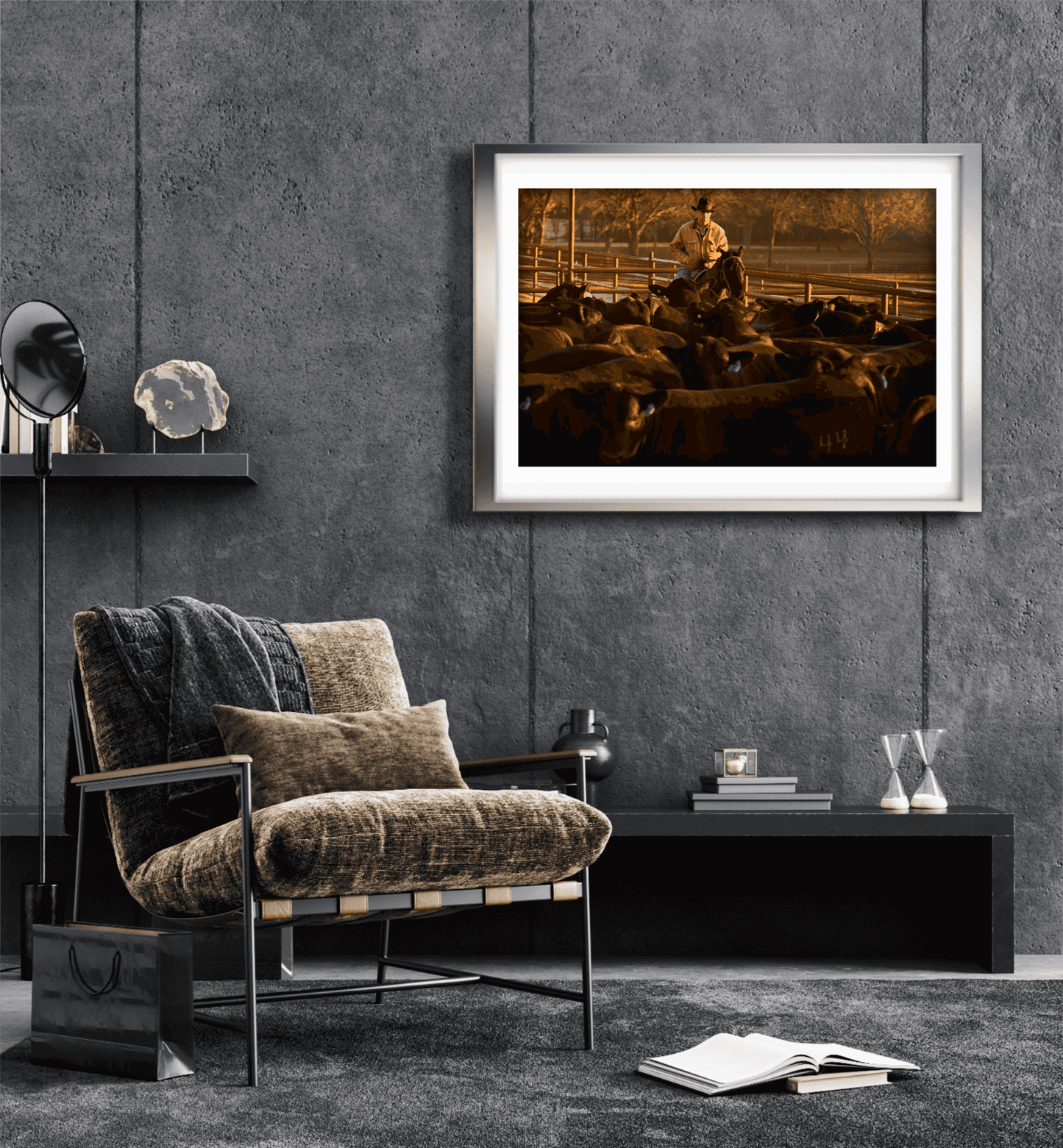 Framed Morning Roundup at 44 Farms cowboy and cattle print by Michael Hart displayed in a modern dark-toned living room with minimalist decor.