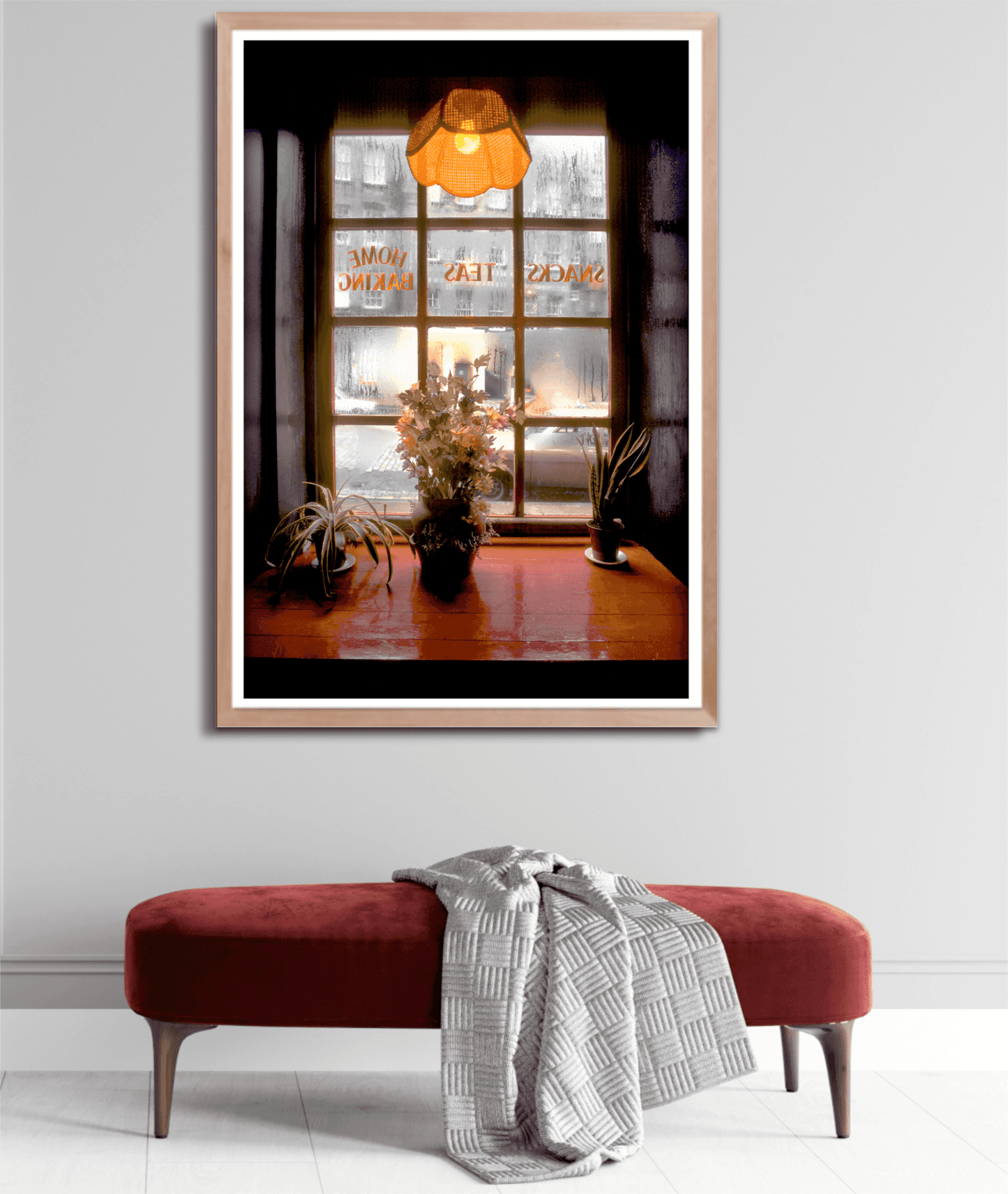Framed Kodachrome print of Royal Mile tea room scene with glowing lamp and frosty window, styled above a red velvet bench in a cozy hallway.