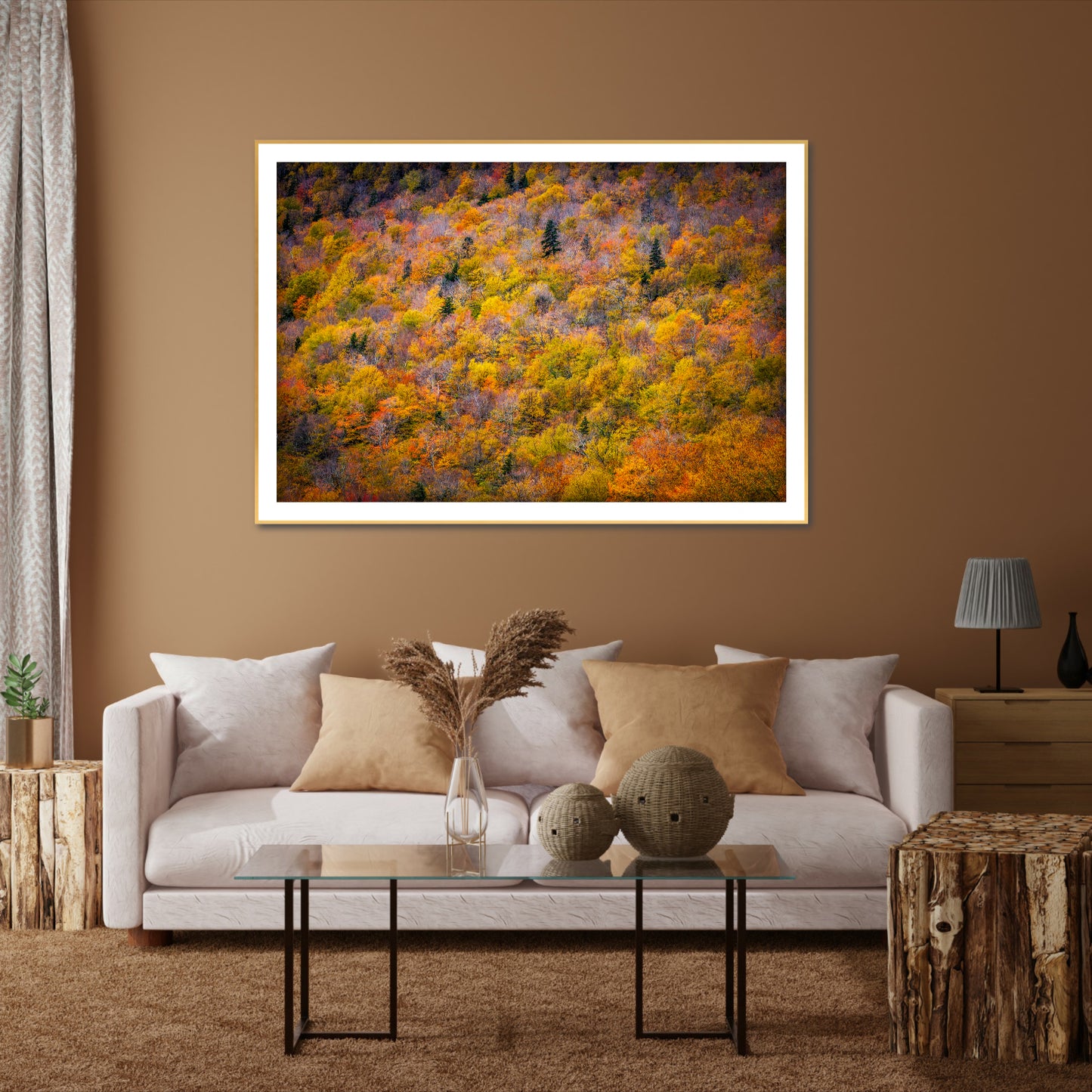 Canopy of Color is a framed photographic image of the tops of a field of trees in the New England autumn shown on the wall of a room setting