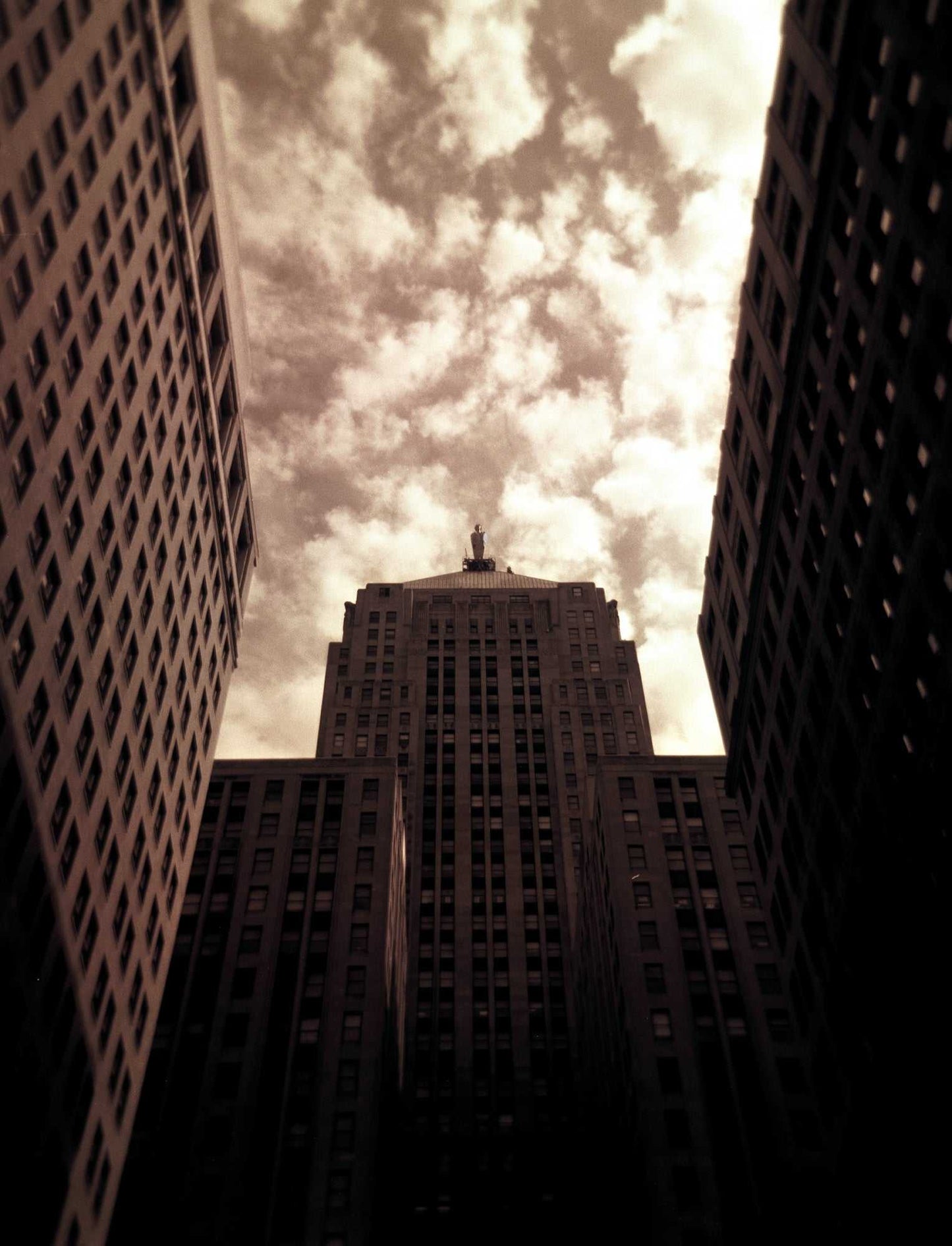 Board of Trade #1 – Sepia toned Holga photo of Chicago Board of Trade with dramatic sky and Art Deco architecture in vertical composition.
