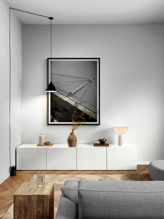 A framed black and white Holga camera image of the Golden Jubilee Bridge in London, England in a modern room setting