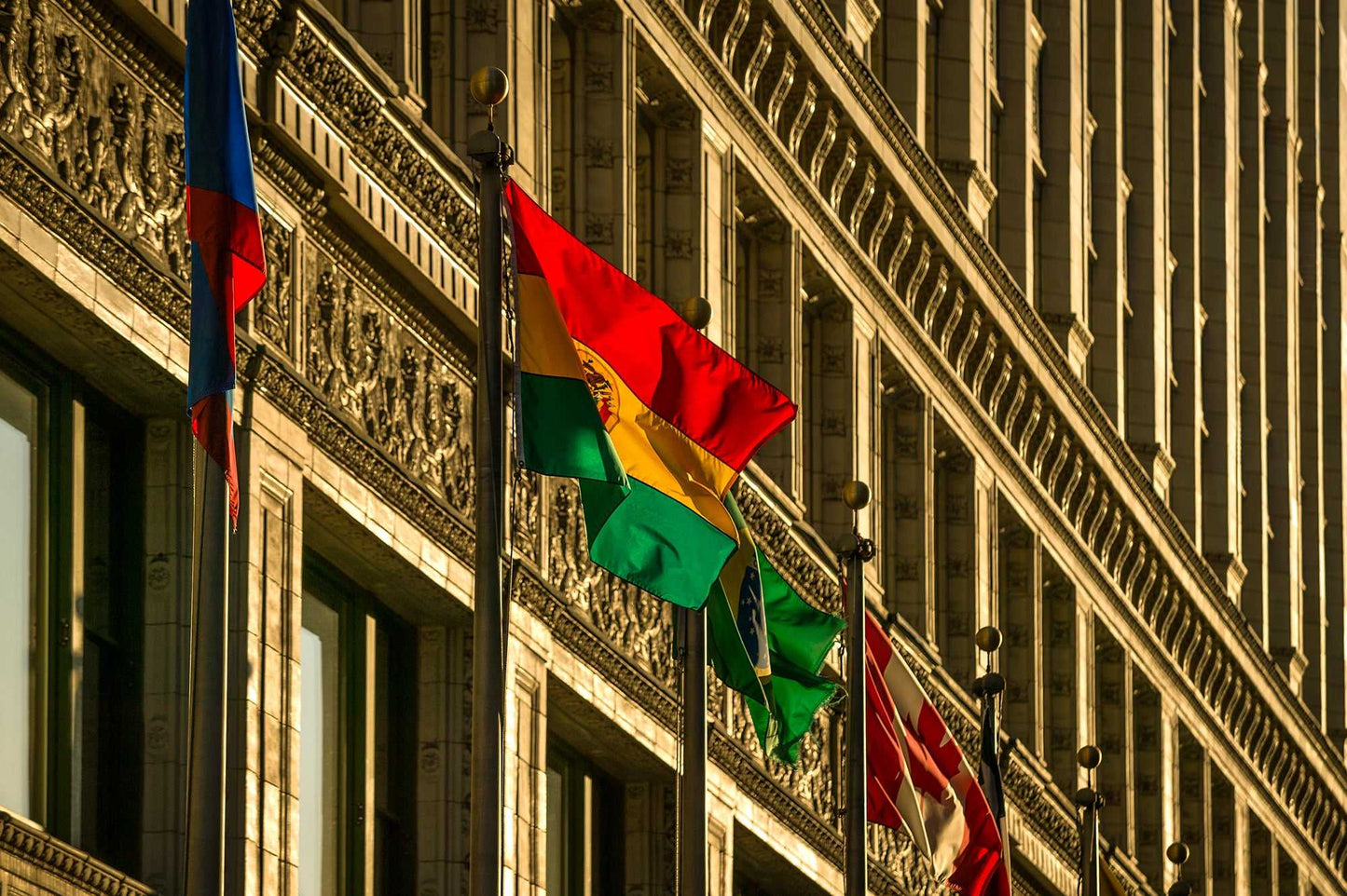 Flags on Wacker – Chicago Art Photograph | Limited Edition print showing colorful flags waving along Wacker Drive's historic architecture at golden hour.