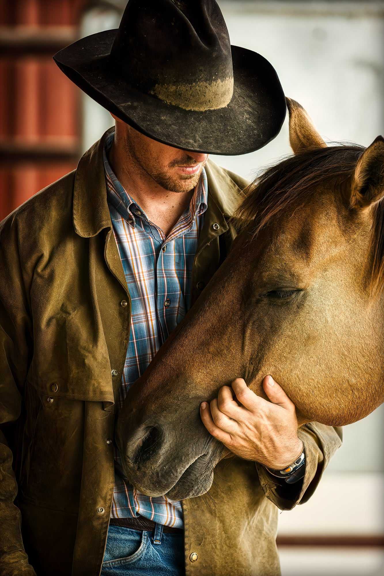 Best Friends – Fine Art Cowboy & Horse Photography, Intimate Color Portrait showing a cowboy tenderly holding his horse’s head in a stable setting. A limited edition Western lifestyle print capturing emotional connection and ranch authenticity.
