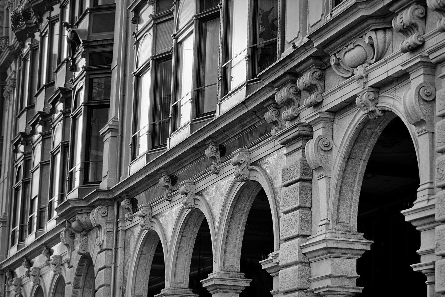Zurich Series #4 – The Architecture Speaks: Texture and Detail in Zurich – Fine Art Print by Michael Hart captures ornate arches and historic European facade in black and white. Ideal for collectors of European architecture photography.