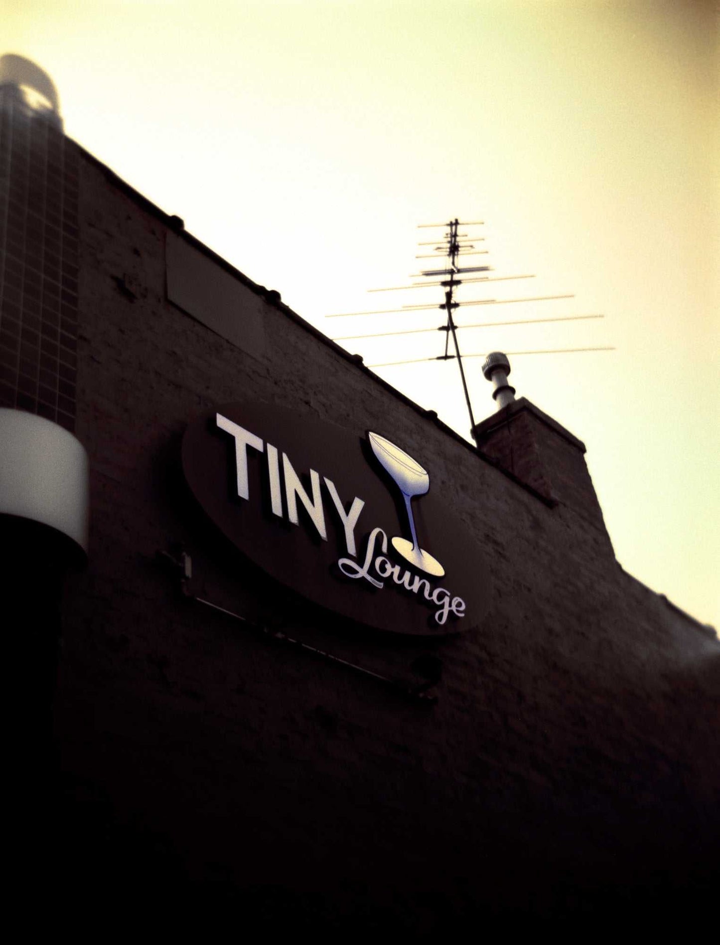 A film image, shot on a Holga camera, of the signage at The Tiny Lounge, an iconic small bar that used to exist in Chicago, Illinois
