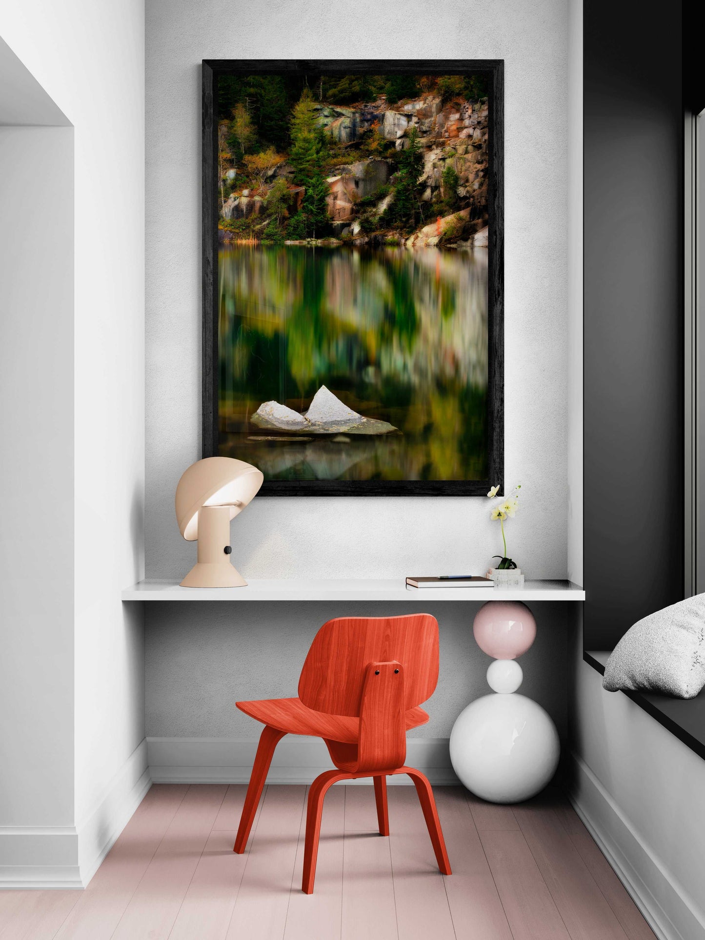 The Sentinel – A Lone Rock Emerges Above The Quarry Waterline, Maine framed artwork decorates a cozy desk nook with minimalist furniture and soft lighting.