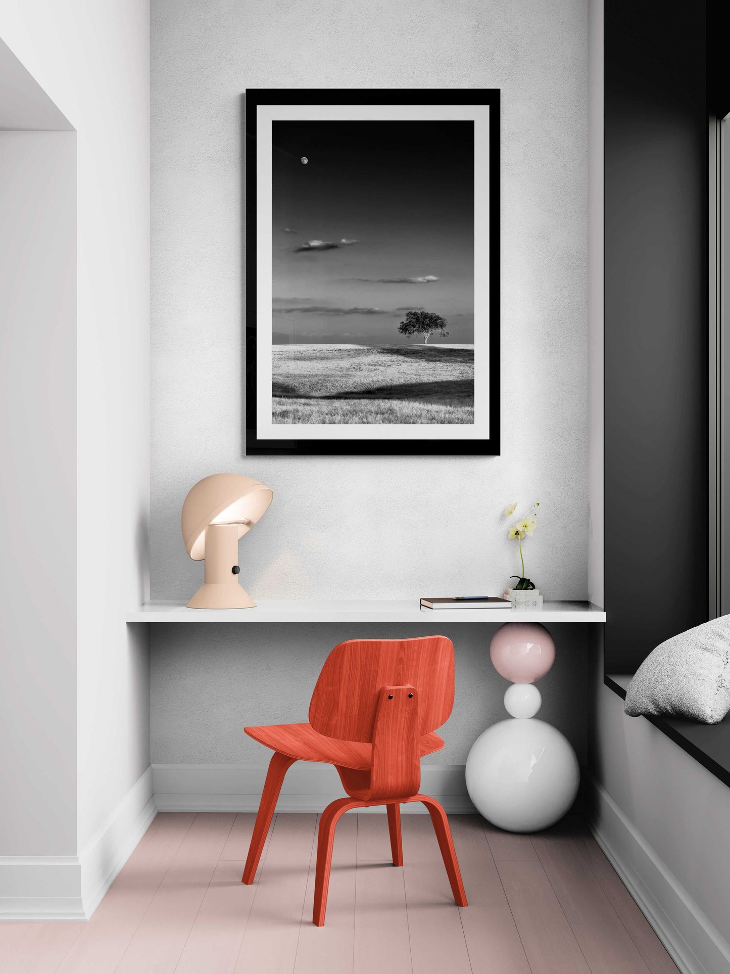Moonrise at Sunset – Black and White Texas Landscape Print by Michael Hart styled in a cozy reading nook with a red chair and soft lighting.