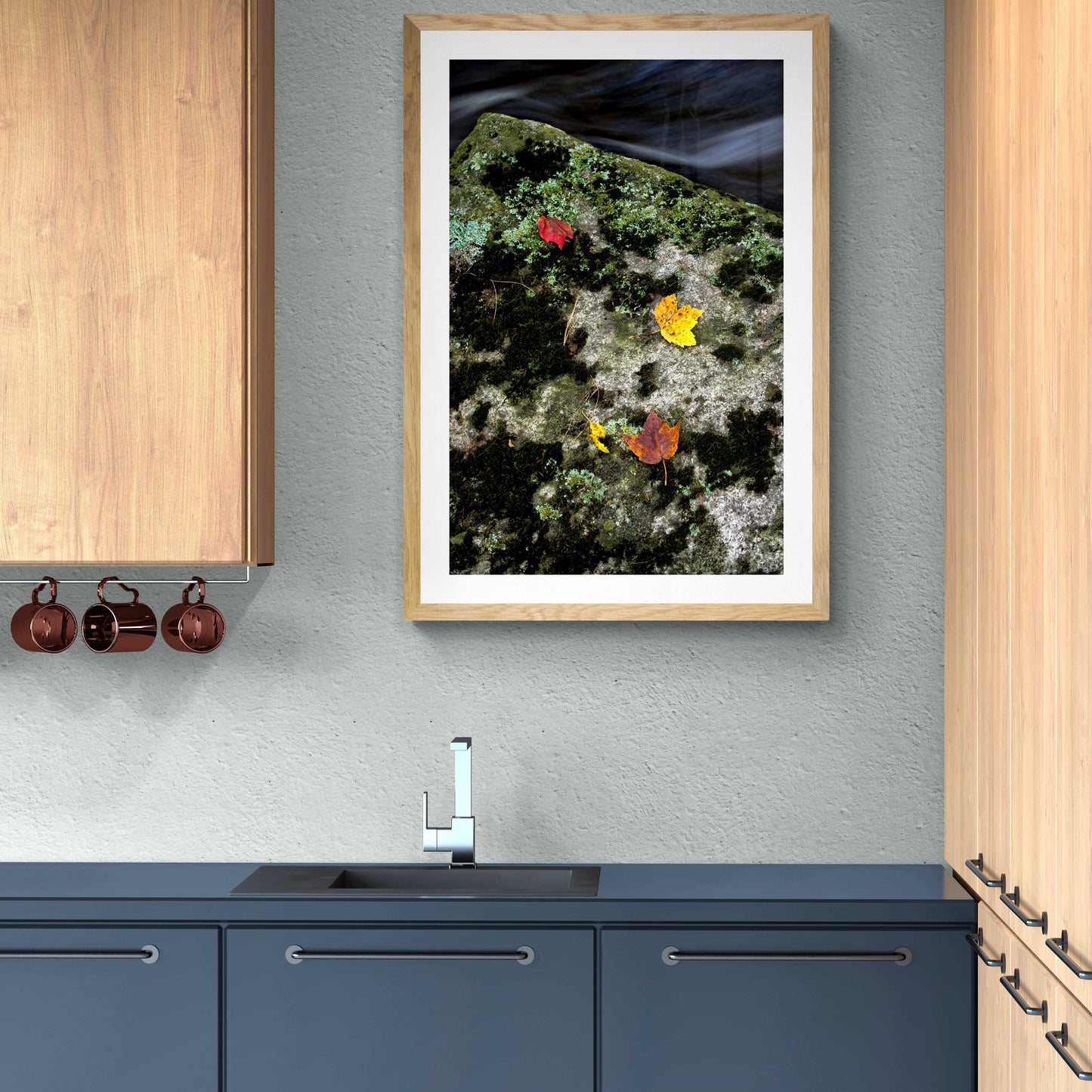 Autumn Remains – Limited Edition Photograph in a wood frame above a modern kitchen sink, adding natural elegance with golden leaves and moss detail.