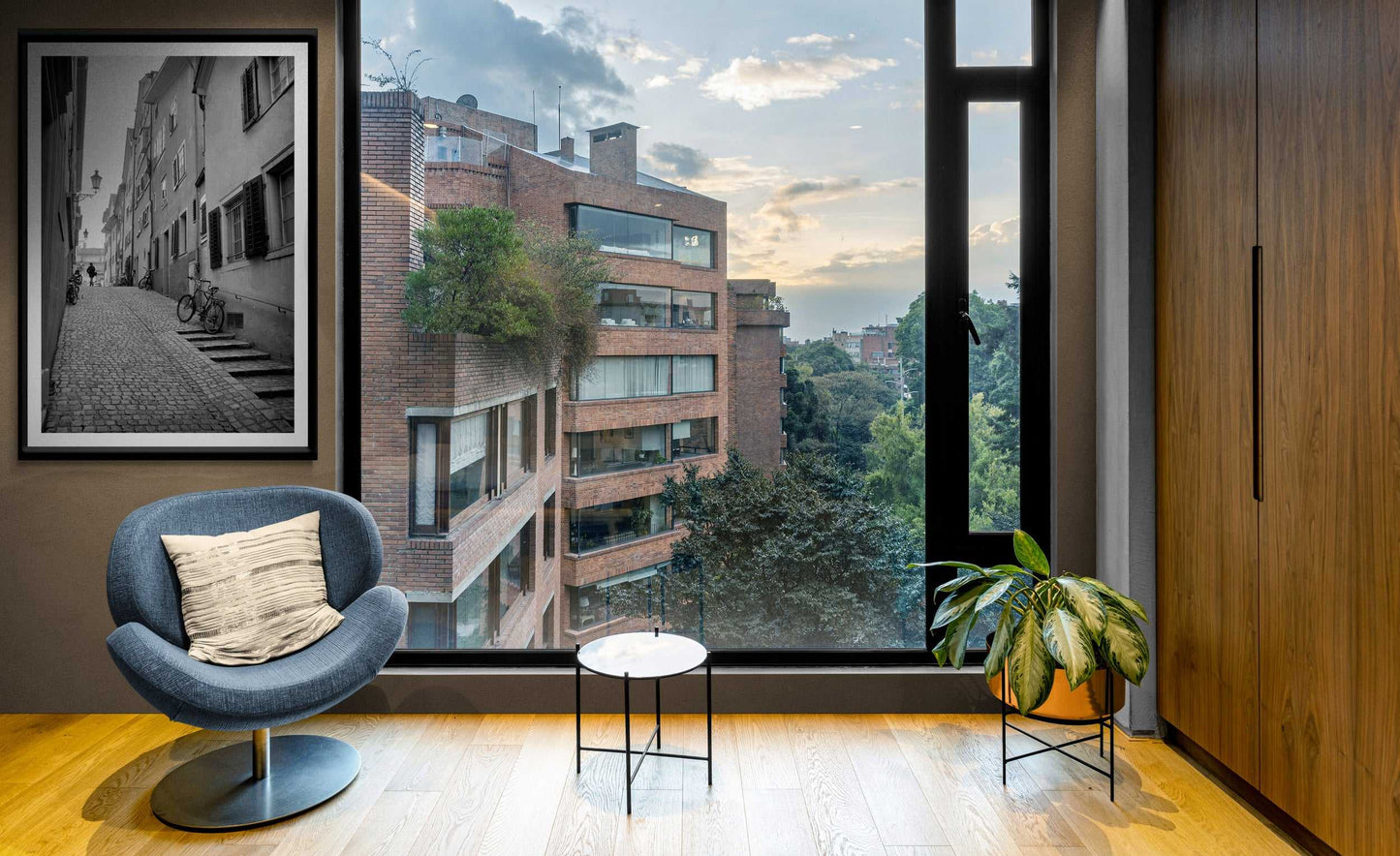 Zurich Series #5 black and white fine art print by Michael Hart displayed in a stylish living room with city views. European street scene complements urban decor.