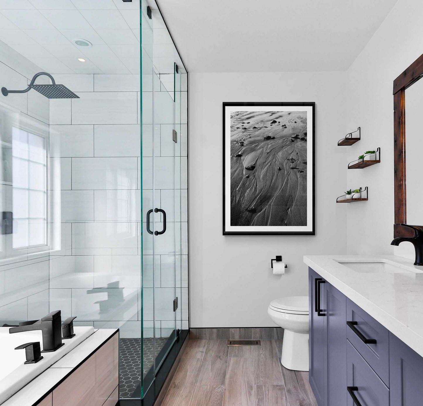'Traces #3' black and white sand photography print displayed in a sleek bathroom, adding natural elegance and texture to contemporary decor.