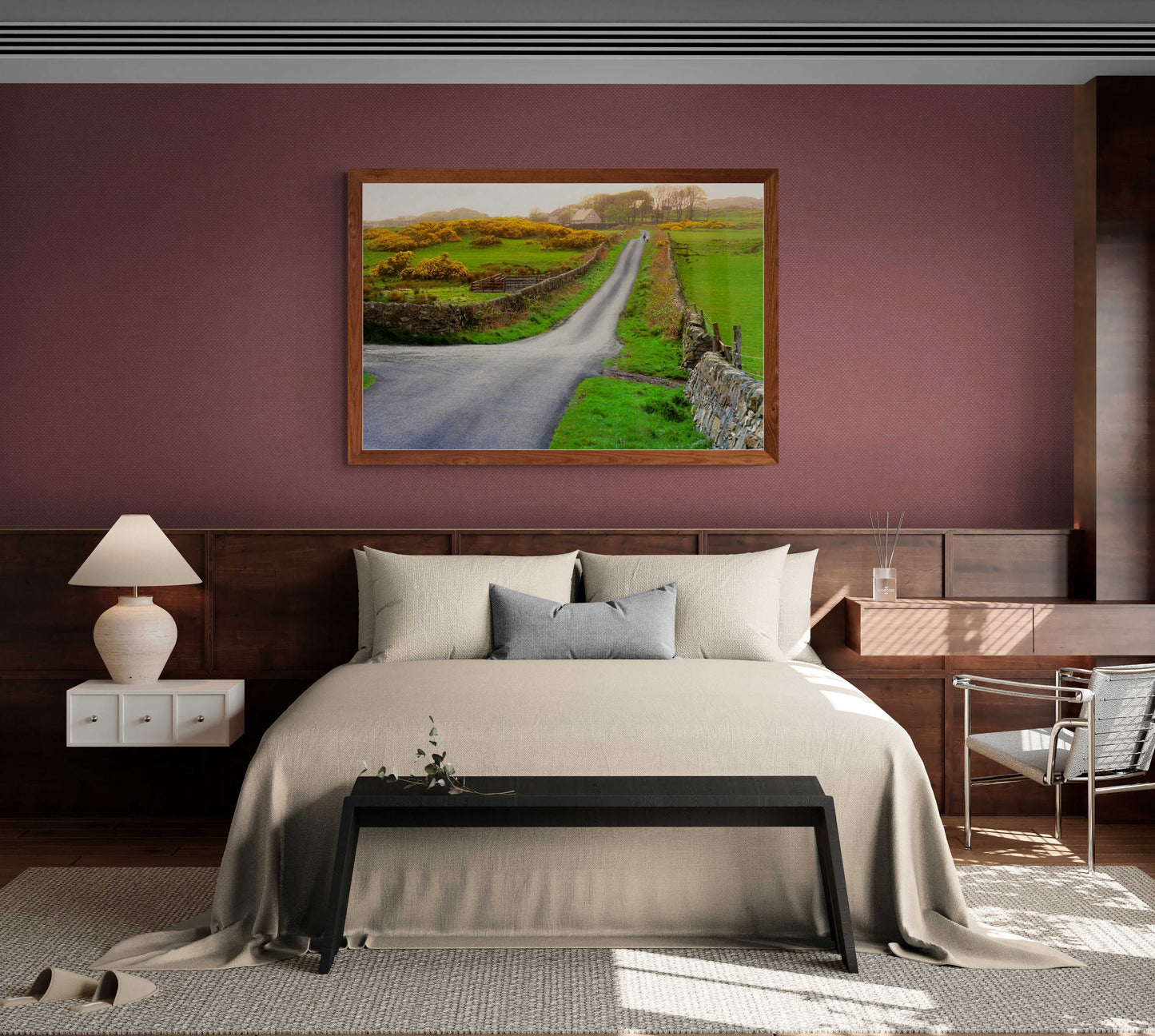 Islay Whisky Scenic Print above a bed in a cozy bedroom, depicting a serene rural road with a lass and dog in the Scottish countryside.