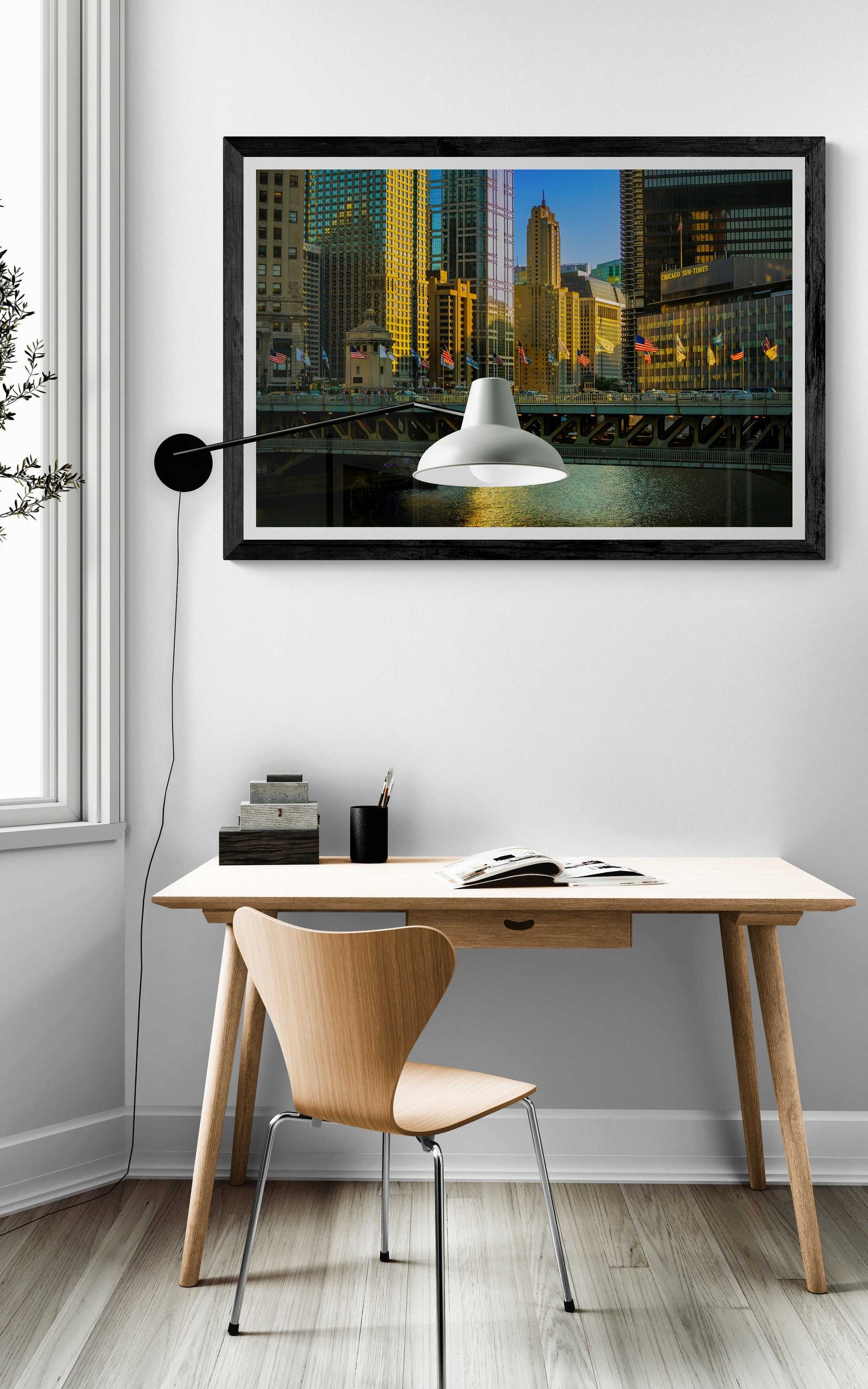 Framed Chicago River #2 fine art photograph of Sun-Times Building in golden light, enhancing a cozy reading nook with natural light and wood tones.