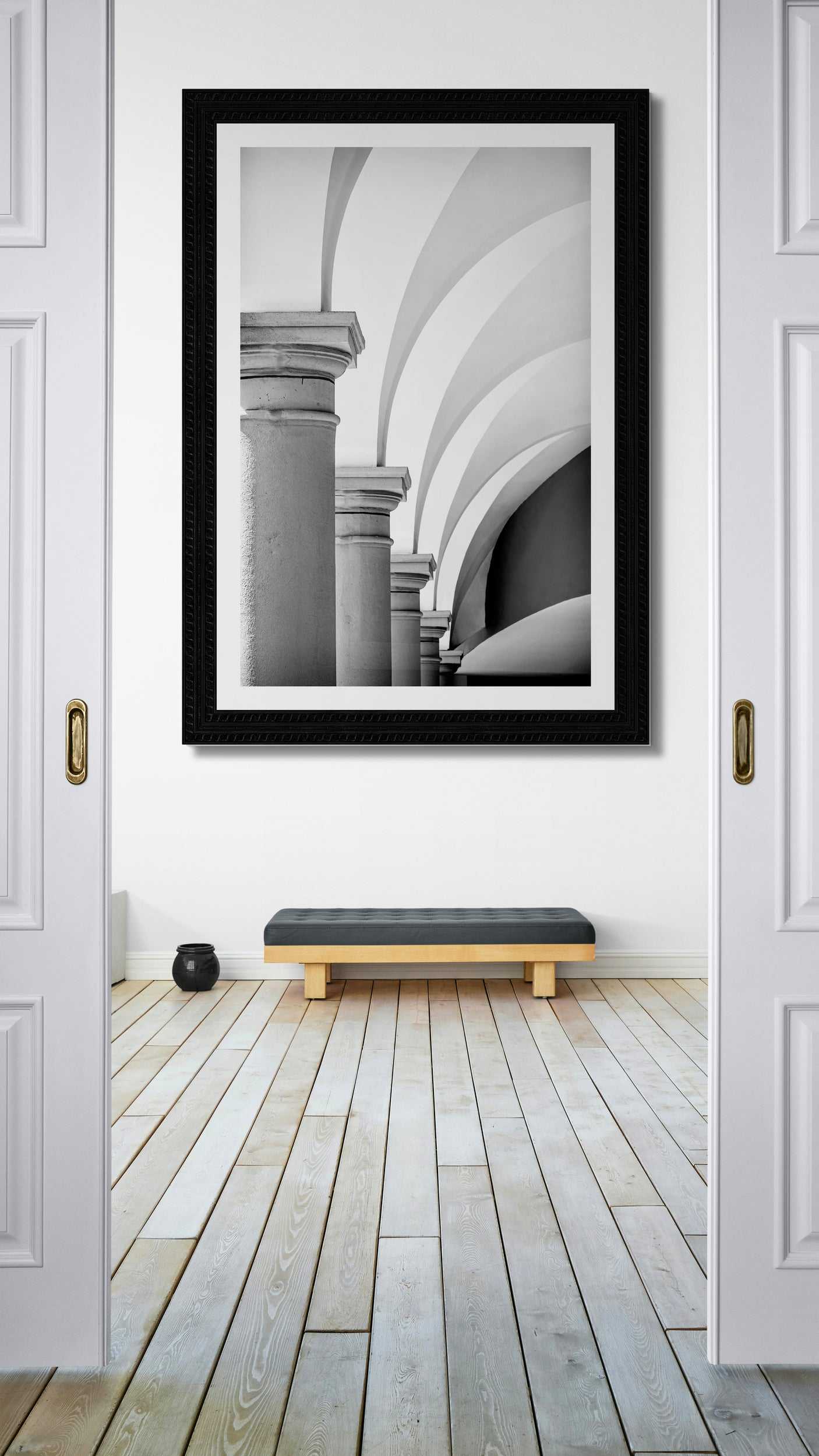 Arches, Barberino – Limited Edition Black and White Photograph of Italian Architecture displayed in modern interior. Vertical wall art featuring Tuscan arches in monochrome tones.