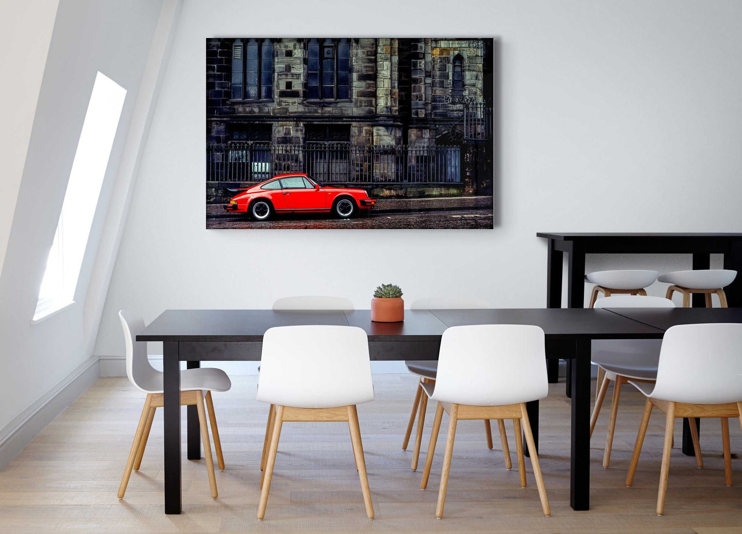 Red Porsche street scene artwork in Edinburgh’s Old Town, mounted in a minimalist dining room with black and white furniture.
