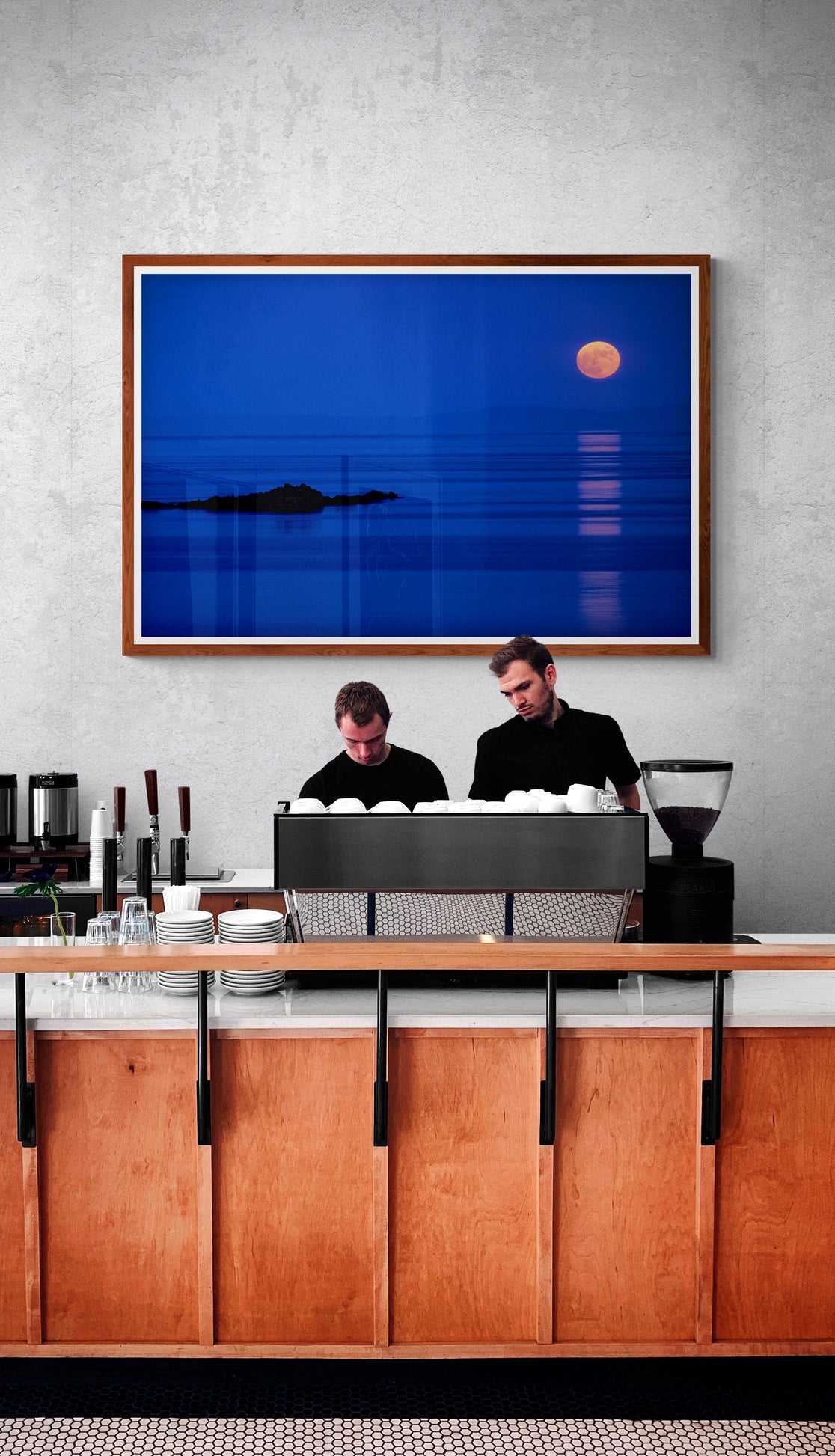 Islay Moonrise over the Atlantic – Fine Art Twilight Photography displayed above a café counter, bringing atmospheric Scottish seascape charm to commercial interior decor.