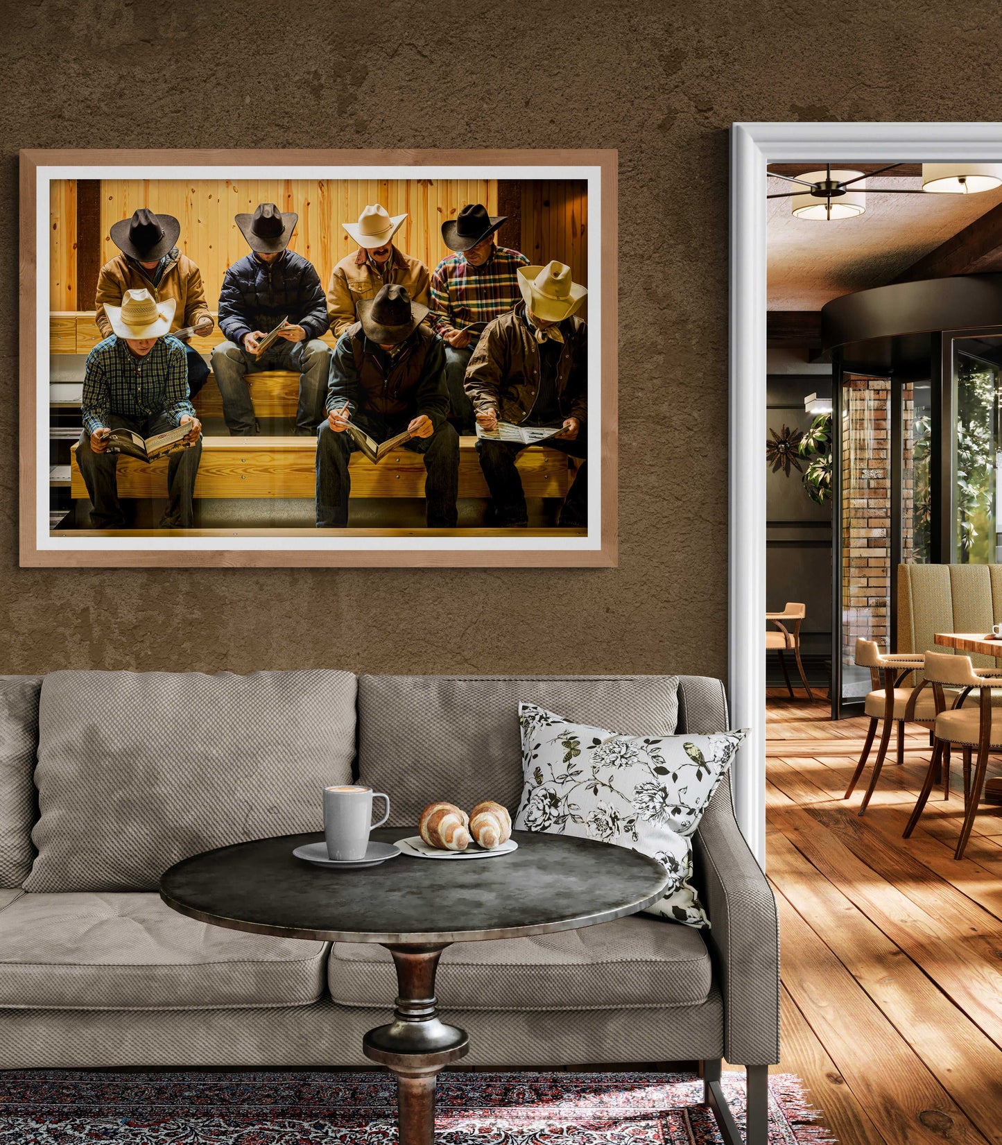 Before the Sale limited edition Western heritage artwork framed above a neutral-toned sofa in a cozy living room with rustic accents.
