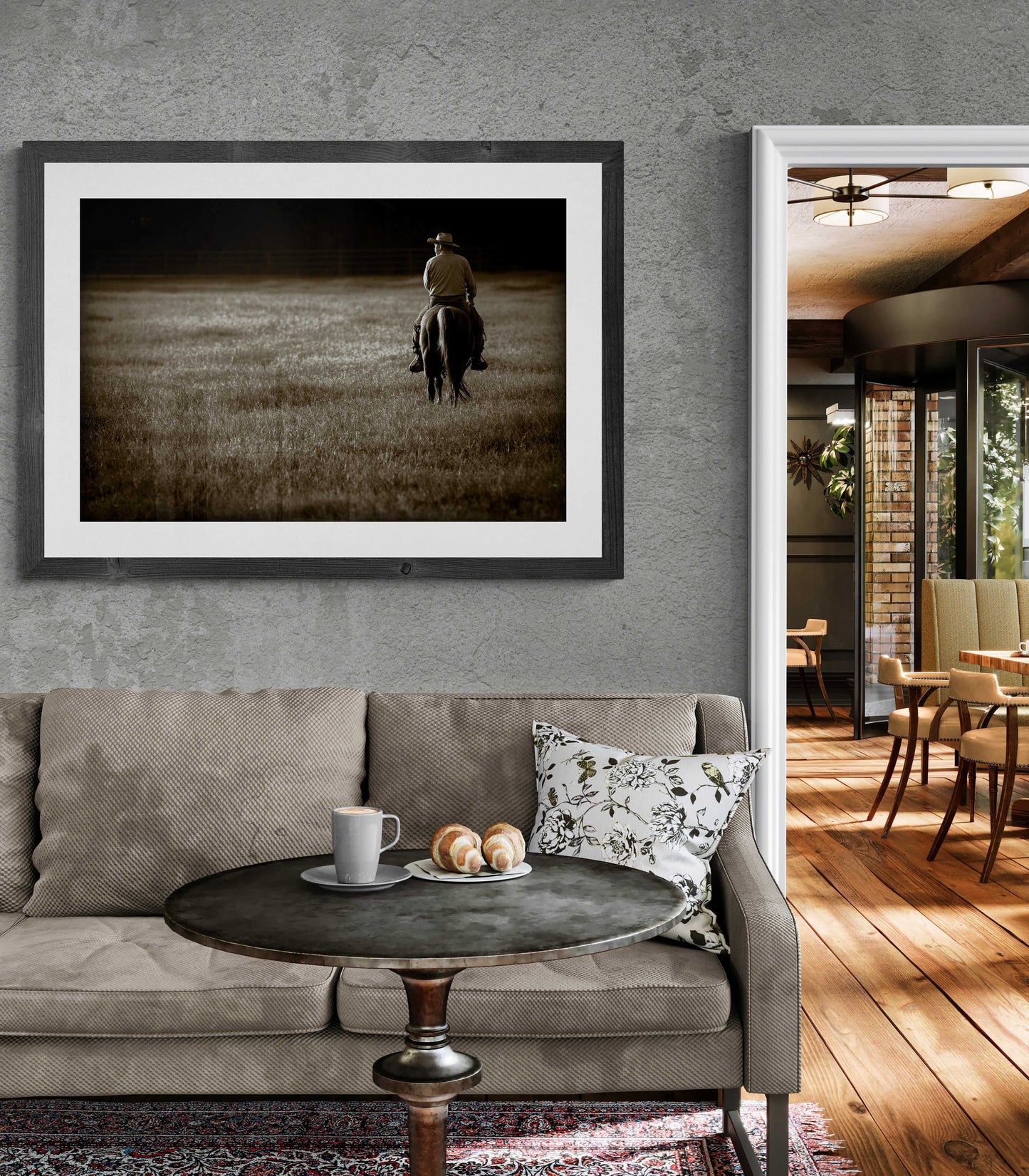 Sepia-toned cowboy print The Lone Rider displayed in a stylish living room. Texas horseback rider fine art for Western-themed home decor.