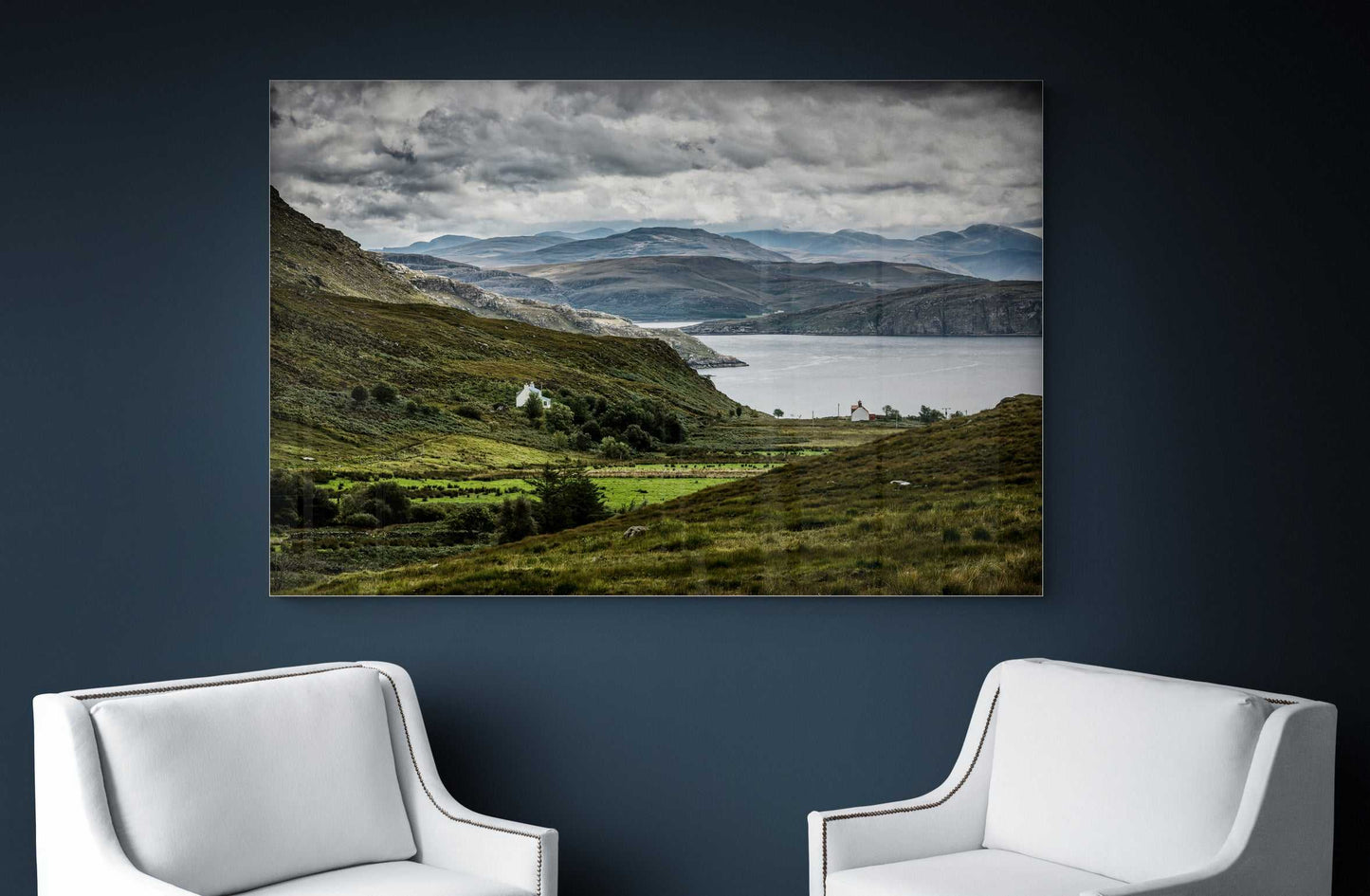 Culnacraig – Scotland’s Wild West Coast in Light and Shadow limited edition print in a dark-toned lounge, framed between two white chairs for contrast.