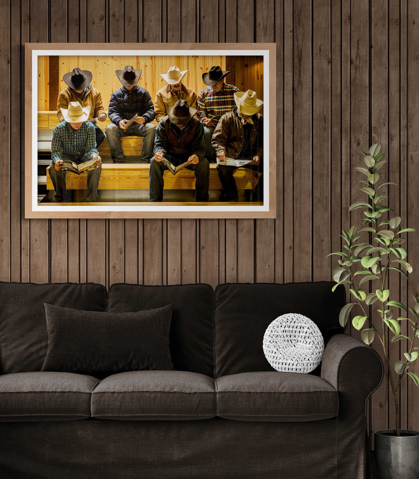Before the Sale Texas ranch photography print mounted on a wood-paneled wall above a dark couch, enhancing Western-themed home decor.
