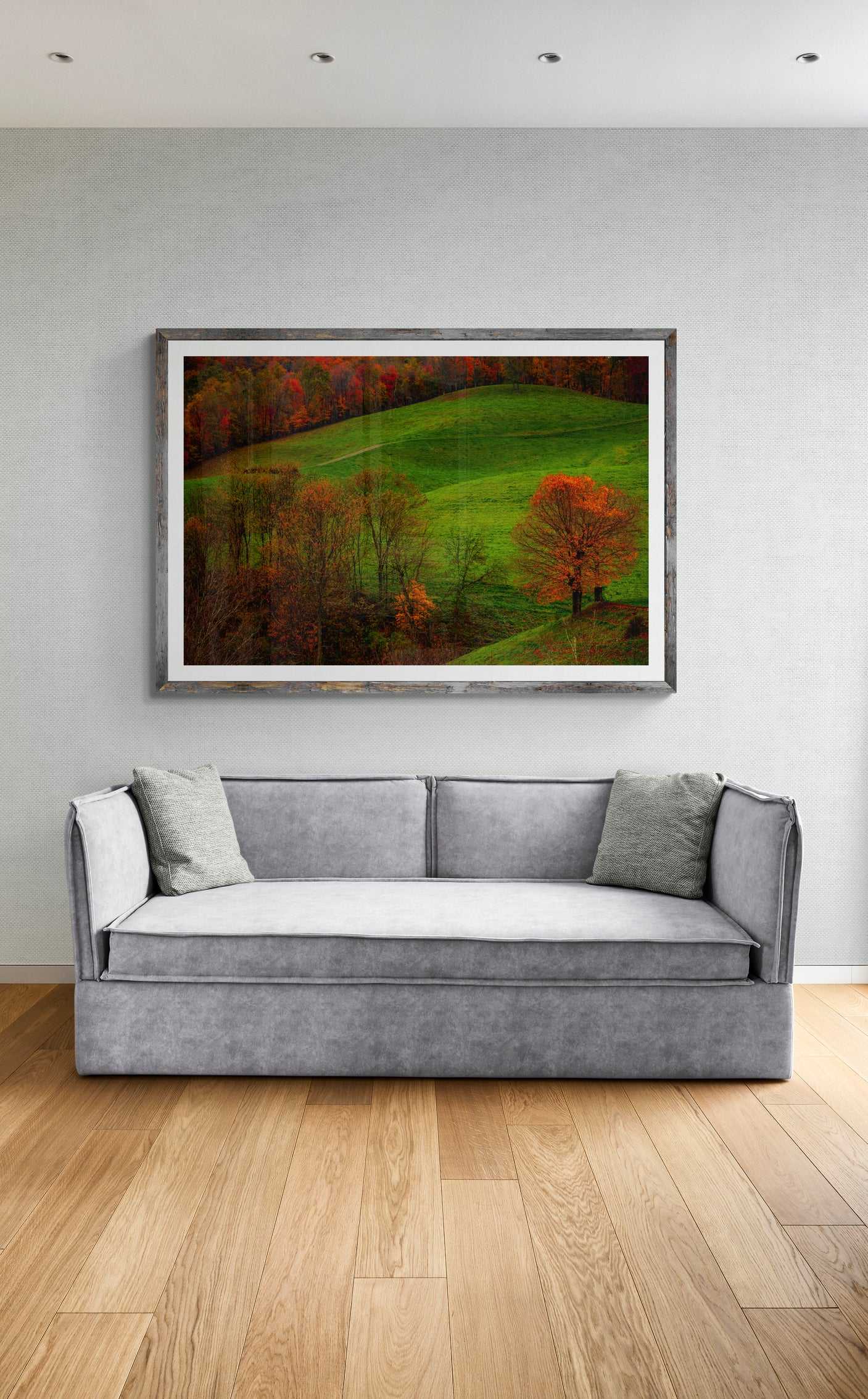 A framed print of West Virginia Autumn hanging on the wall in a room setting