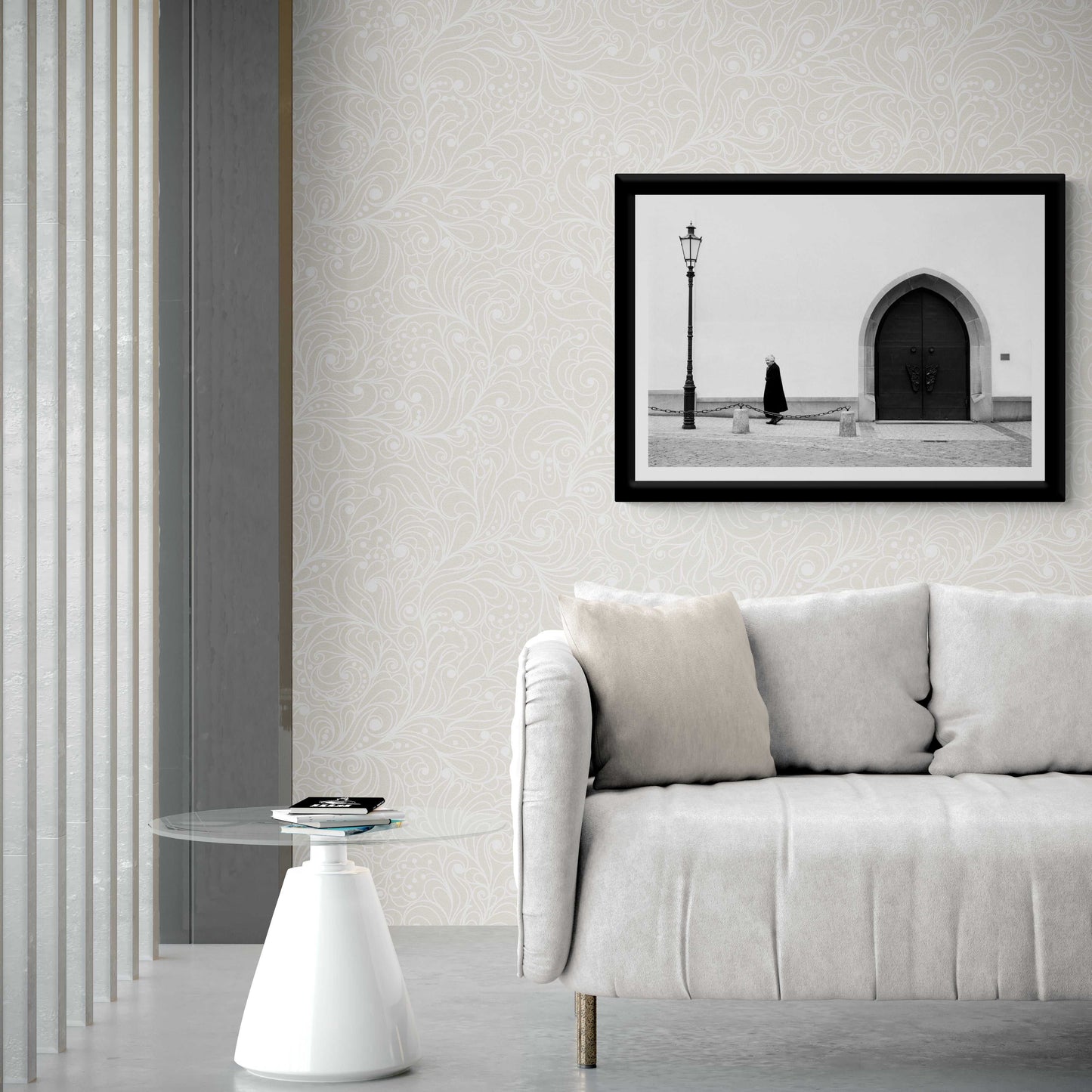 Zurich Series #2 – The Woman and the Church, Black and White Fine Art Print by Michael Hart framed above a white sofa with patterned wallpaper in a stylish home setting.
